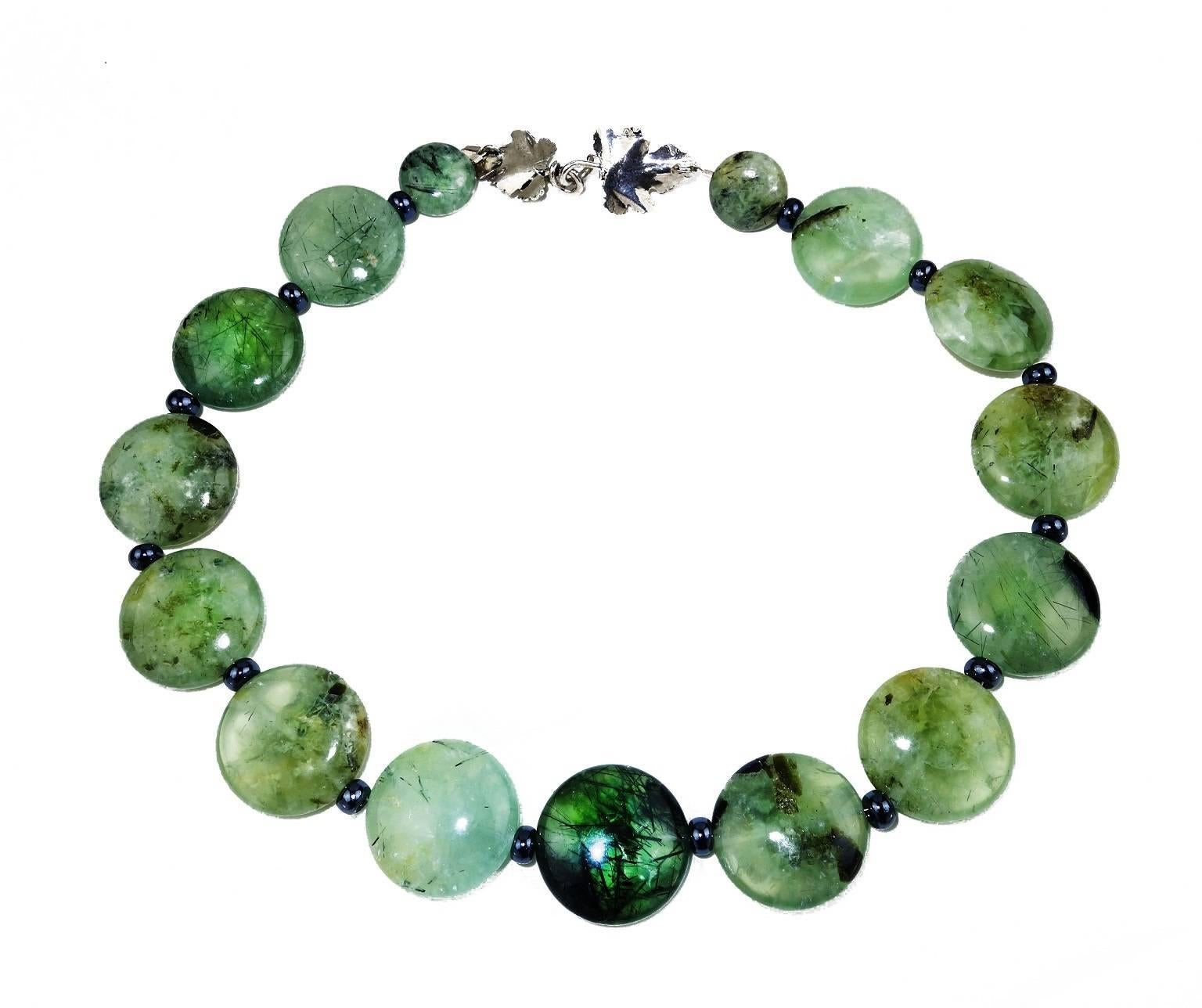 Gorgeous Necklace of Distinctive Green Brazilian Prehnite  25mm Discs accented with shiny gray spacers.  The clasp is a beautiful Turkish Sterling Silver, double  sided leaf motif that you can slide around  to be a focal.  18 Inches in length.  More