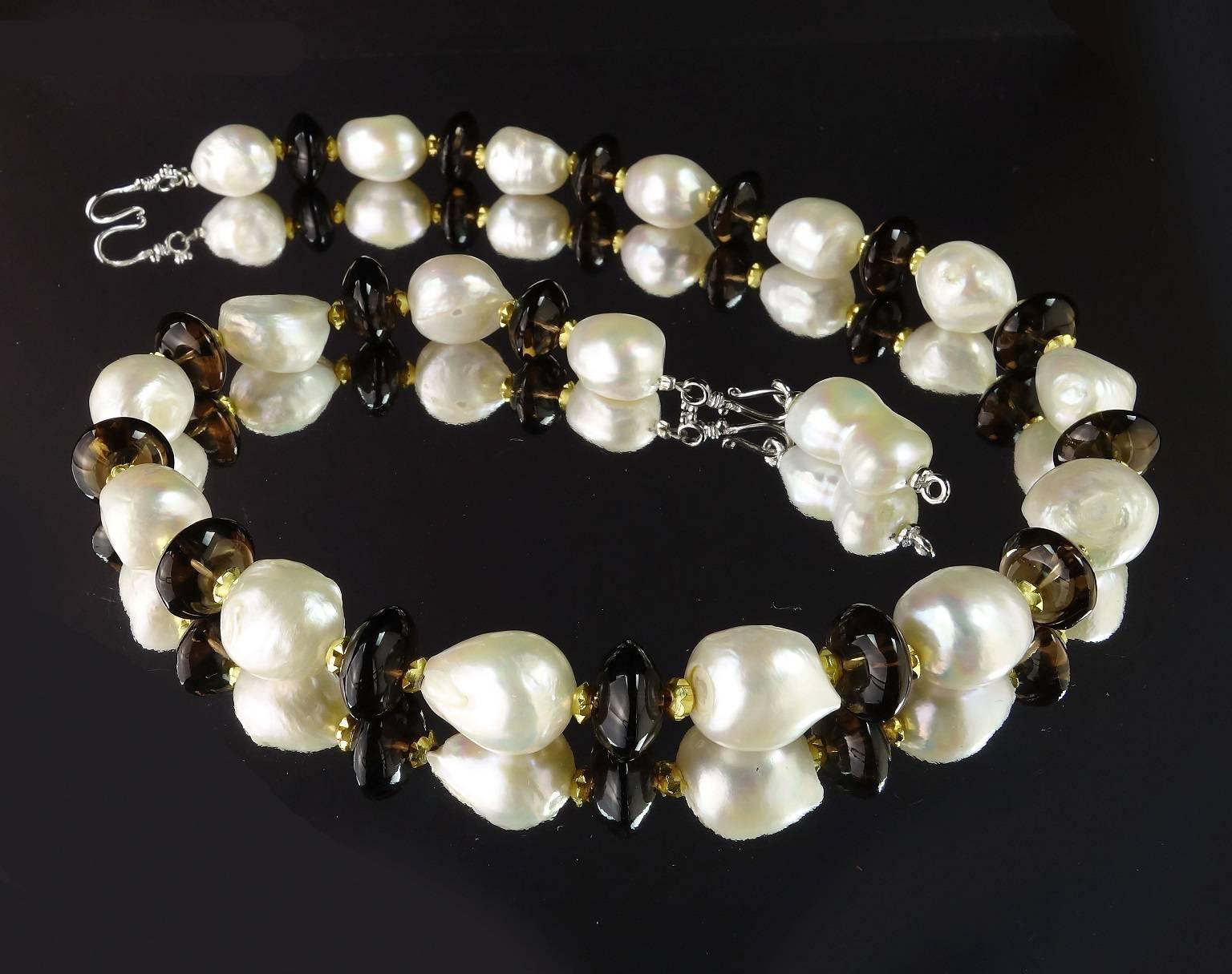 Classic Necklace of White Pearls and Smoky Quartz Rondelles with gold tone accents perfect for all occasions.  This lovely necklace is 18.5 inches in length.   This features a pearl clasp that can be a focal.  The pearls are 11-12mm.  
