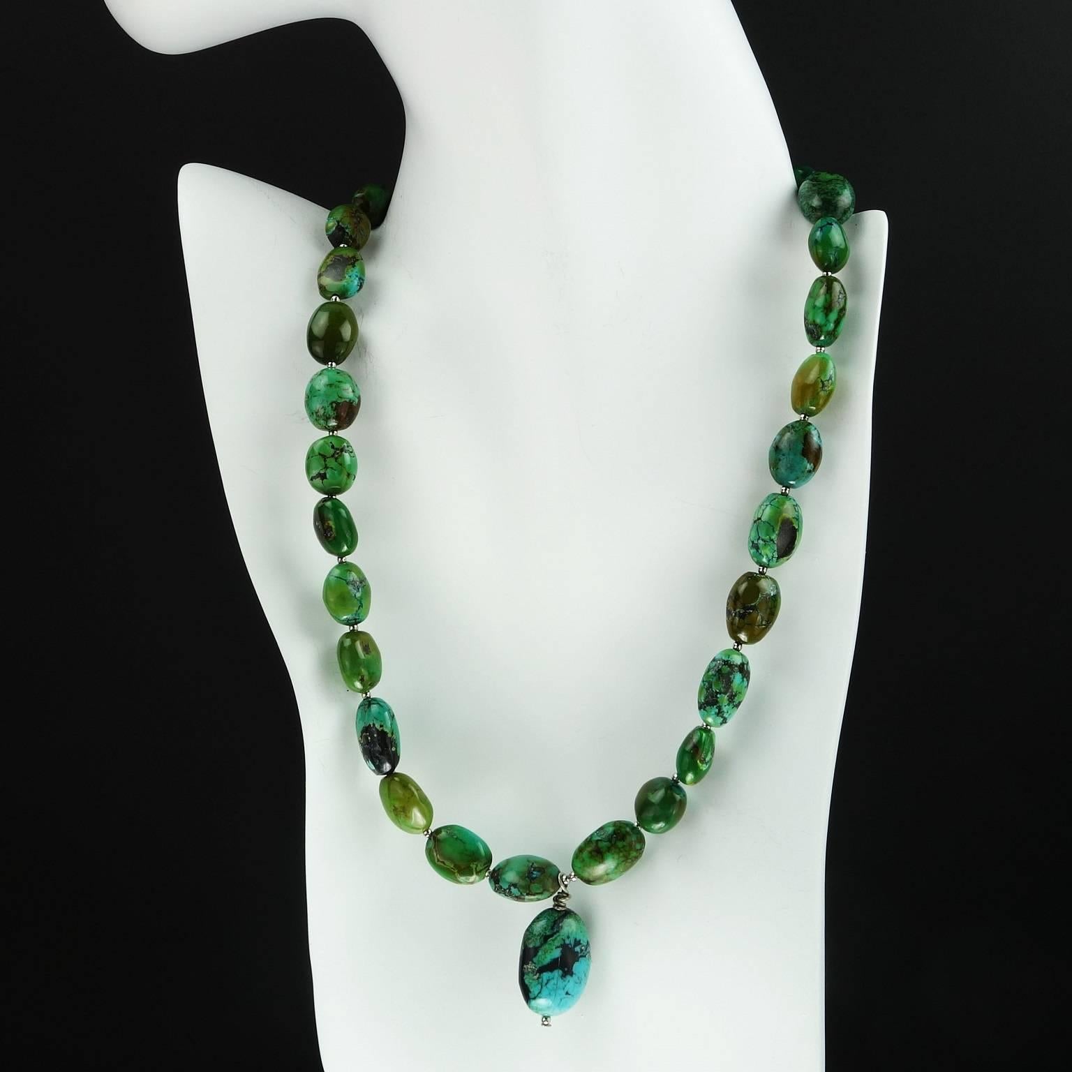 Wonderful necklace of graduated green Turquoise oval beads with Turquoise focal. The oval Turquoise beads range in size from 16x9mm to 11x10mm. The focal is 21x14mm. The closure is a silvertone lobster claw clasp. The overall necklace length is