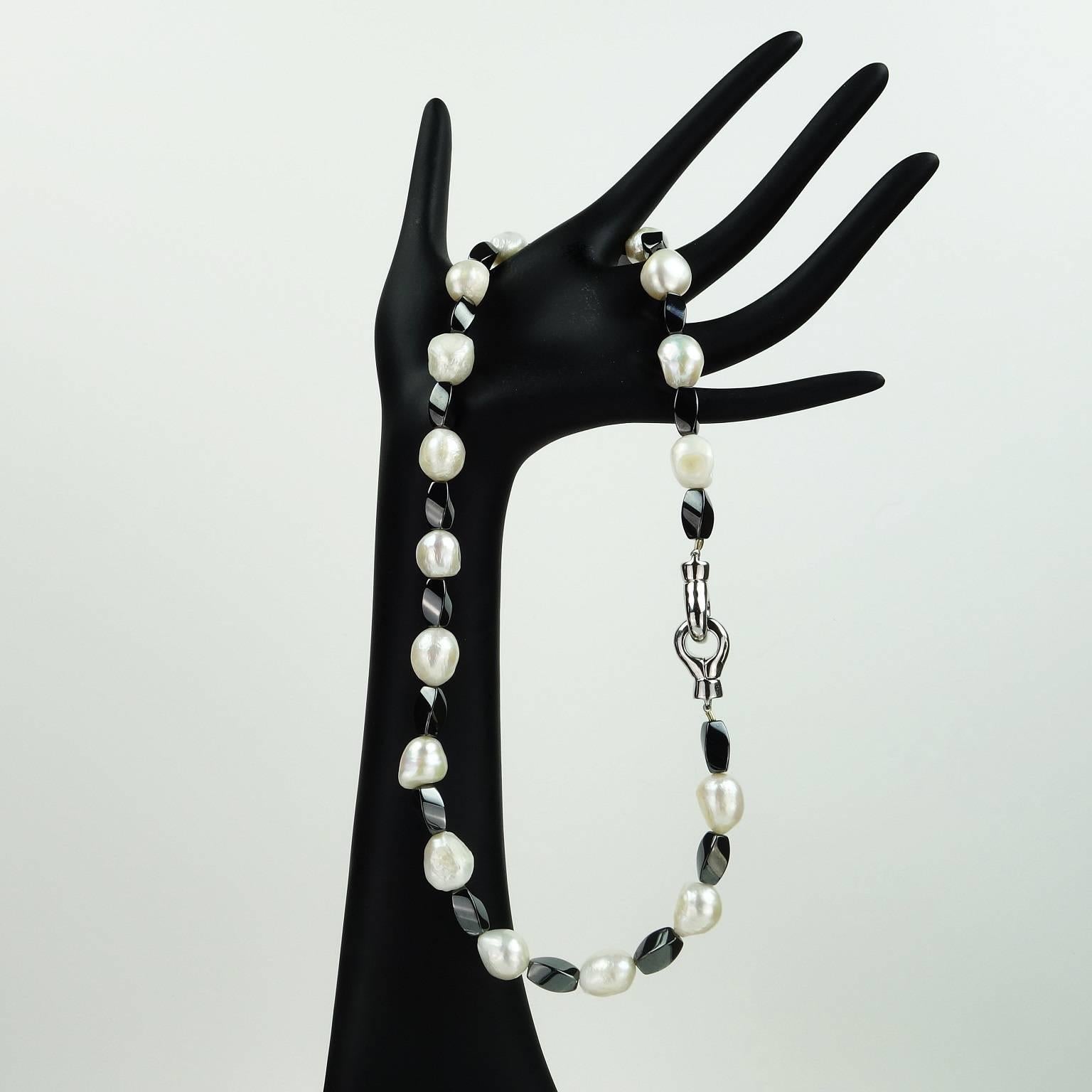 White Pearl and Interesting Twisted Hematite Beads combined in Elegant 19.5 inch necklace with silver tone clasp. Wear this with all your ensembles to kick them up a notch. Pearl in the traditional June birthstone.