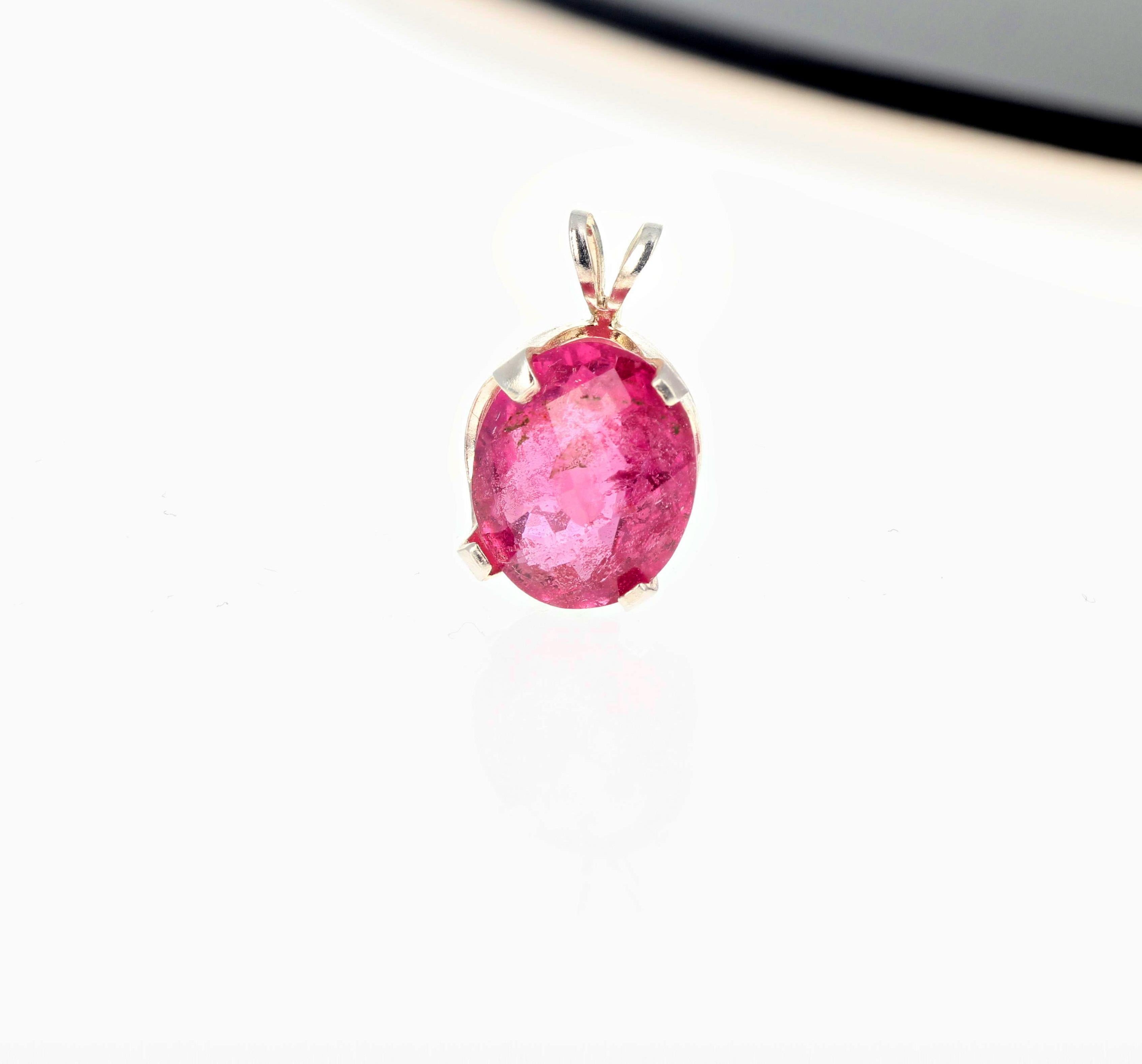This glowing 4 Carat natural glittery pink Brasilian Tourmaline (gemstone is11 mm x 9 mm) is set in a Sterling Silver pendant.  The gemstone is oval with checkerboard cut to sparkle more. 