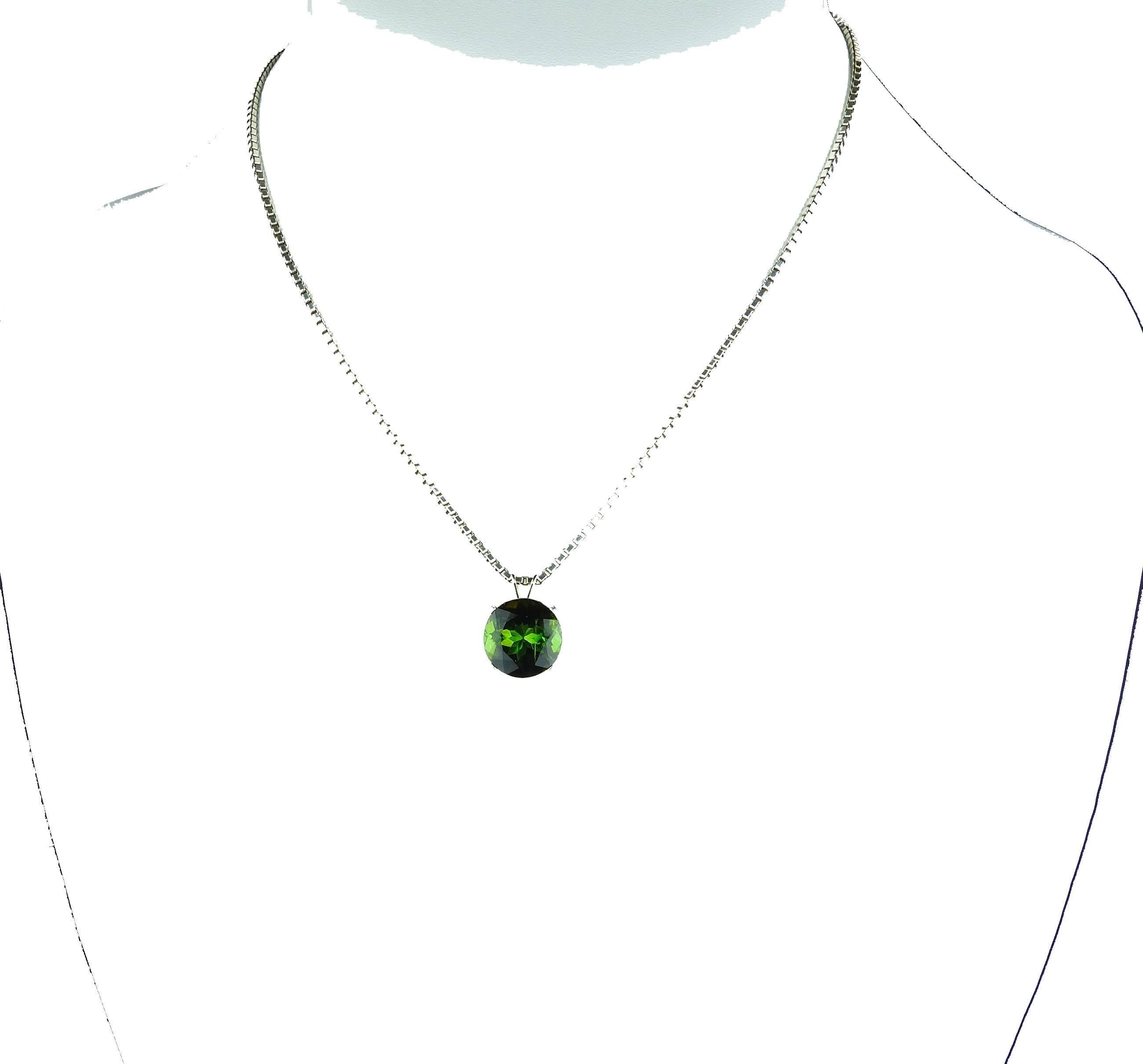 This gorgeous bright real green 5 carat natural Tourmaline is set in a sterling silver pendant.  The gemstone is 11.3 mm across.  This is a beautiful and rare green color and sparkles when dangling around your neck.  