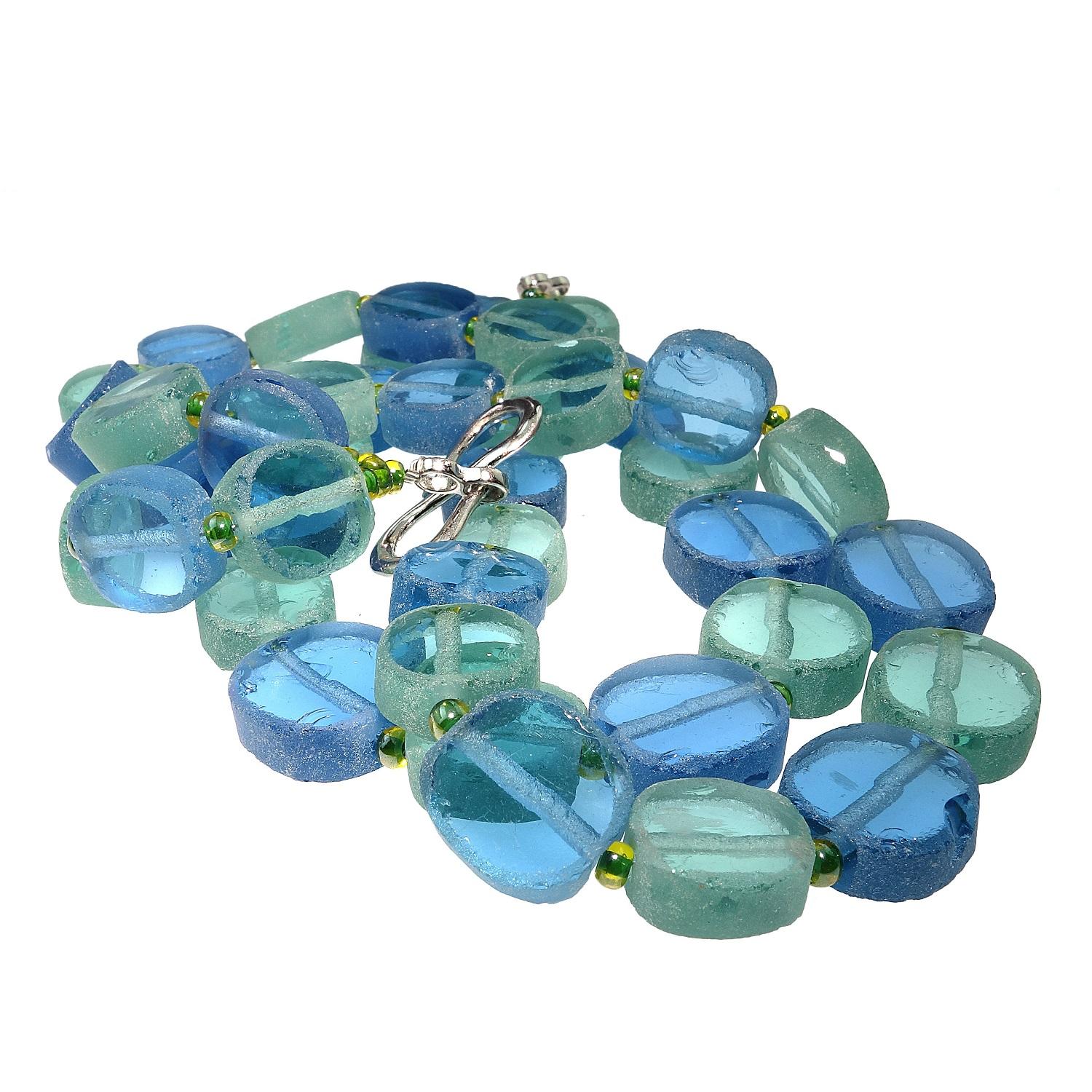 Custom made necklace of two strands of alternating Bue and Aqua green sea glass. These off round discs of sea glass is polished on the flat sides and frosted on the edges and spaced with small Czech beads. The unique necklace is finished with a