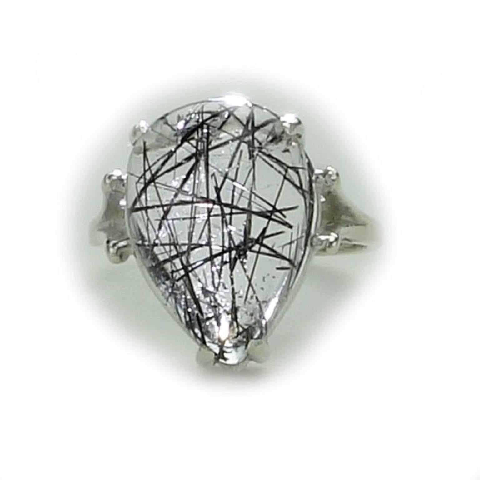 Custom made Sterling Silver ring featuring a sparkling Clear Quartz with Black tourmaline rods in a pear-shaped cabochon. This unique gemstone is from our favorite supplier in the mountains outside of Rio de Janeiro. It is perfect for all of you who