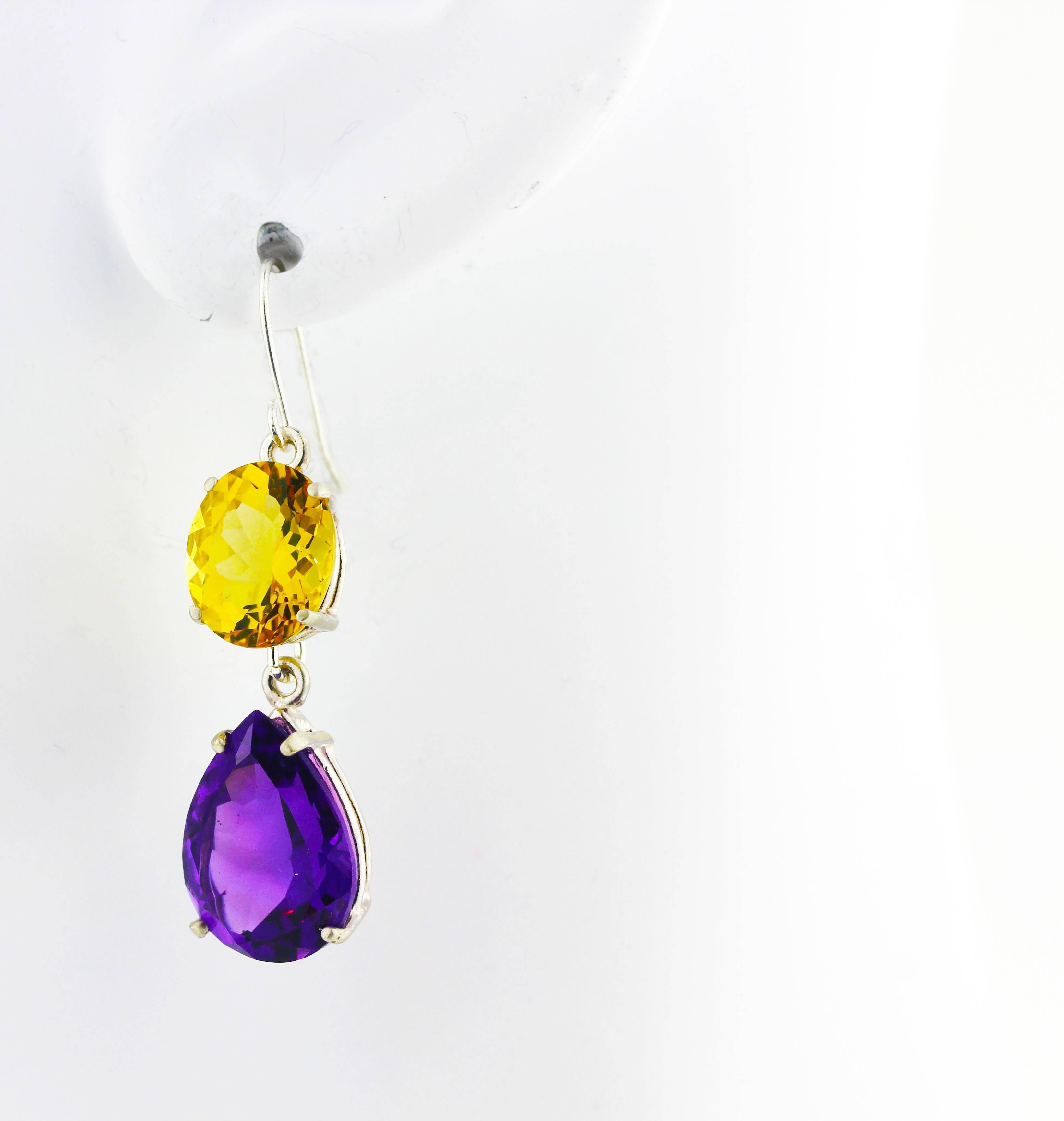 Dangling brilliant purple 12 carats total of pear cut Amethysts (15 mm x 10.7 mm) swing delicately from the beautiful oval 6.85 carats total of glittering natural yellow Beryls (11 mm x 9 mm) sterling silver hook earrings.  They measure 1.6 inches