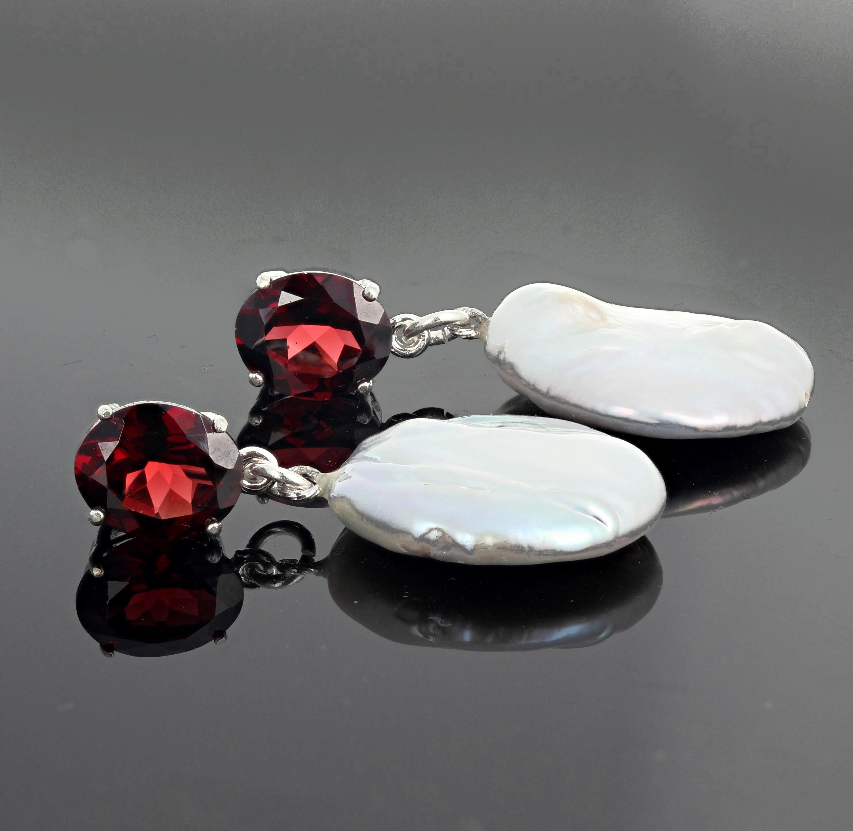 Glittery red very red 8.38 carats of matching oval gem cut natural Garnets (11 mm x 9 mm) dangle beautiful white cultured Coin Pearls on Sterling Silver stud earrings.  They hang approximately 1.5 inches long. These are gorgeous for daytime or