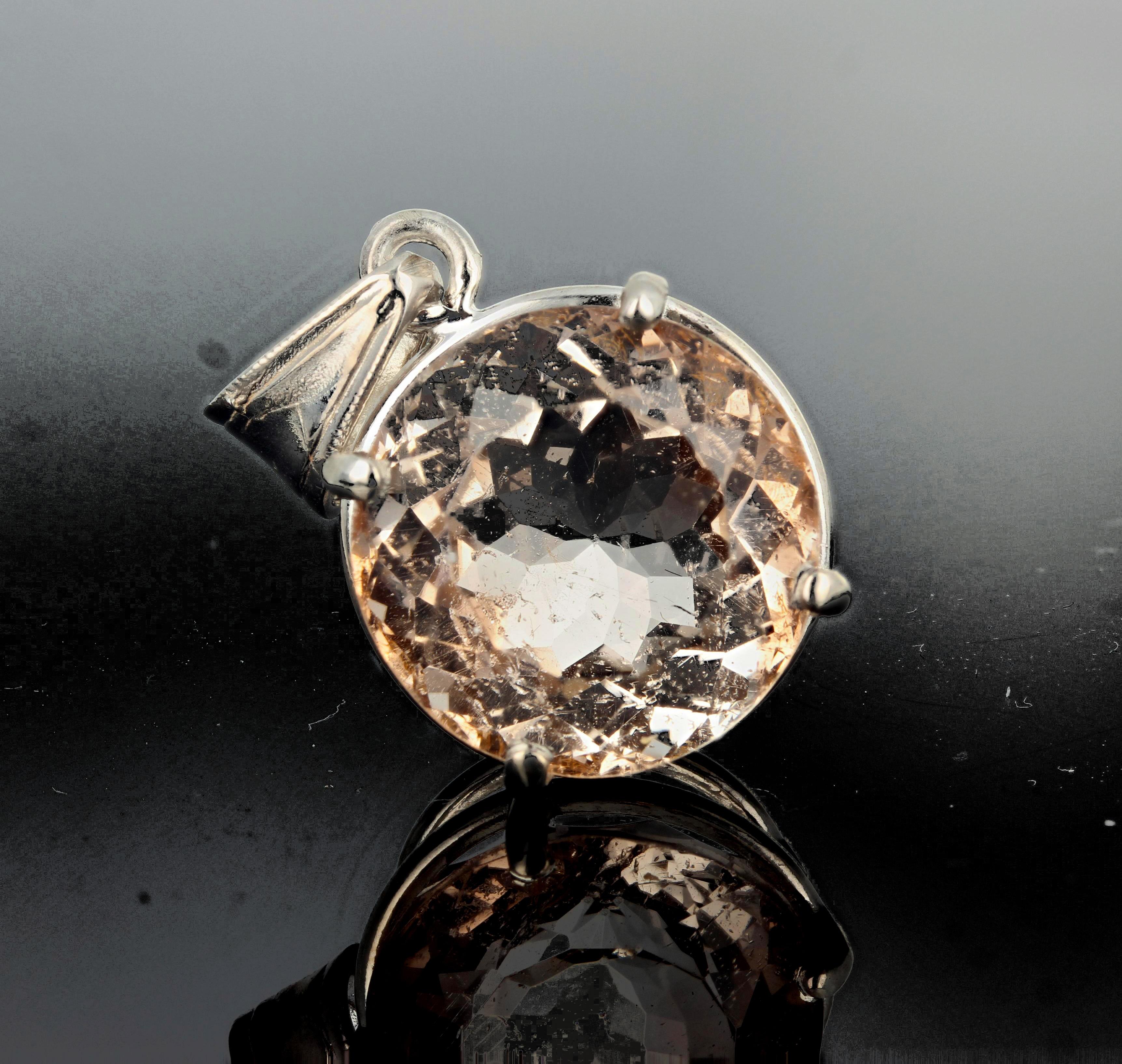 Glittering huge unique round (16 carats) pinky tan natural translucent Morganite (17 mm) set in a sterling silver pendant.  This hangs approximately 1.17 inches long.  Spectacular optical effect in the Morganite exhibits gold reflections and fire