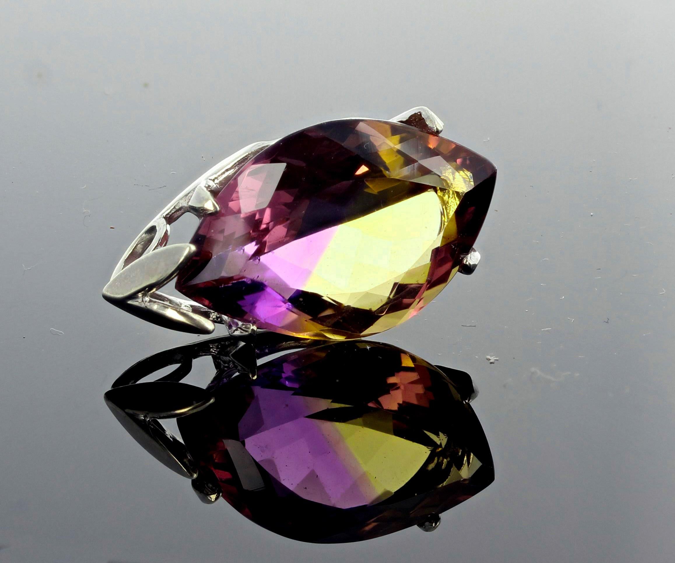 Amazing magic of this 19 carat marquise gem cut Ametrine (part Amethyst part Citrine) set in a sterling silver pendant that hangs approximately 1.15 inches long.  The gemstone is totally natural and measures 26 mm x 15.7 mm).  More from this seller