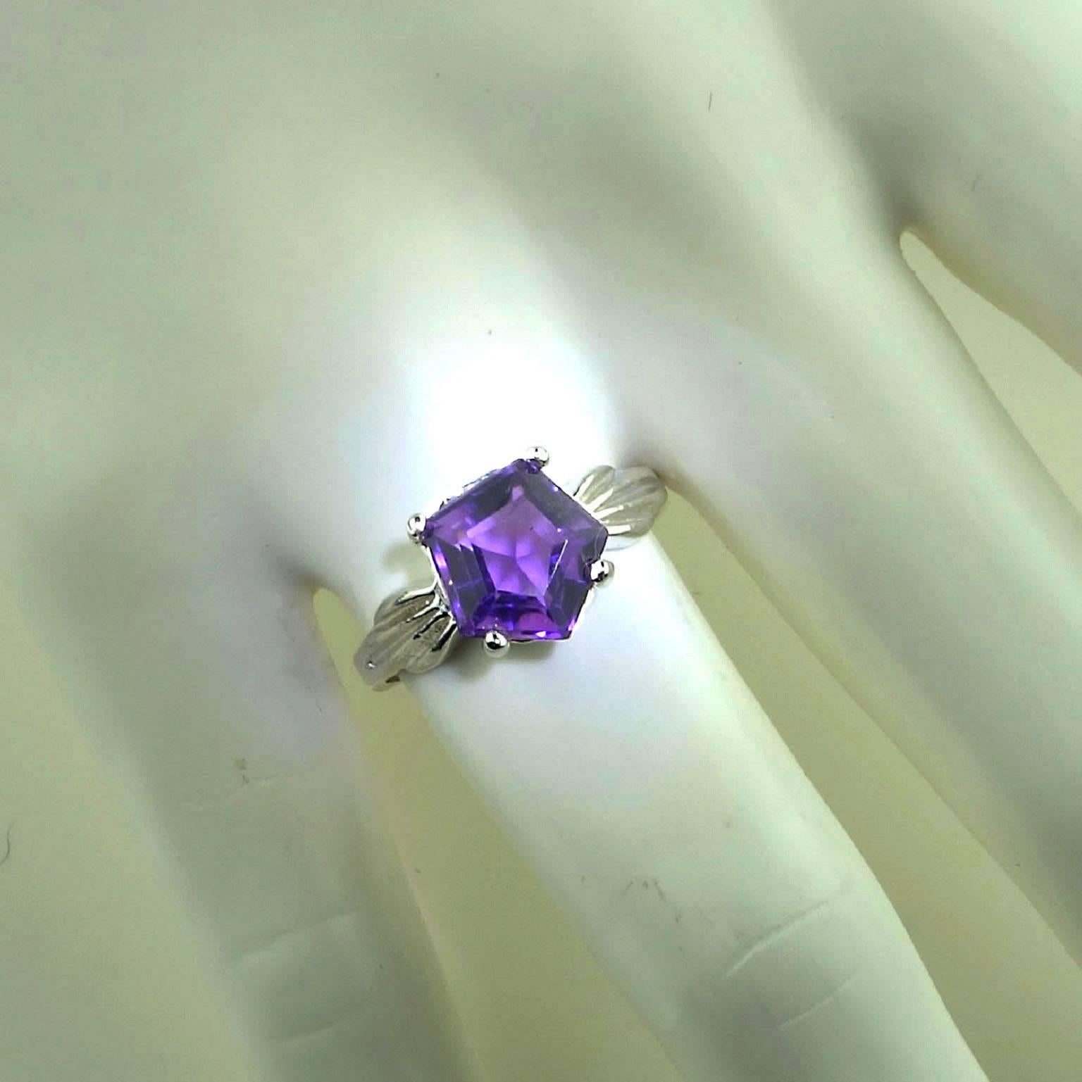 Custom made ,sparkling five sided Amethyst set in a basket of Sterling Silver ring.  The special cut was created in Brazil and we found it with one of favorite suppliers in the mountains outside of Rio de Janeiro. This unique gemstone has a lovely