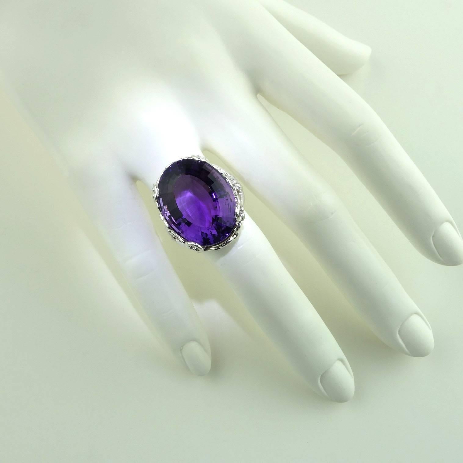 Flashing, huge Brazilian Amethyst set in a lovely open loop design in rhodium over Sterling Silver ring. This Amethyst came from a special parcel from our favorite suppier in the mountains outside of Rio de Janeiro, it is incredibly bright with both