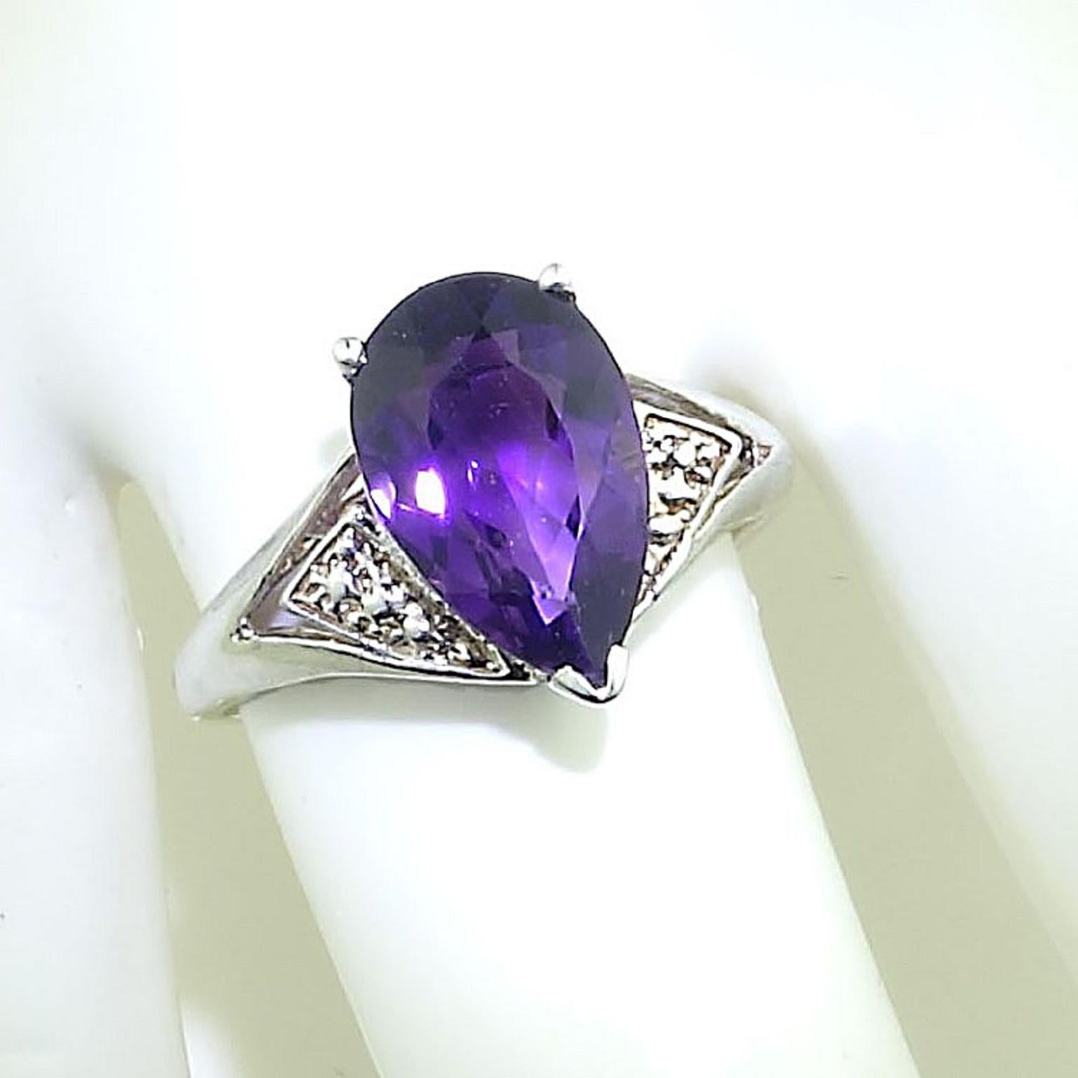 Custom made, sparkling long pear-shaped Brazilian Amethyst set in rhodium plated Sterling Silver ring. This lovely Amethyst is three prongs set above a lovely ring with detail on the shoulders and open work gallery. It is a sizable 8.5.  The