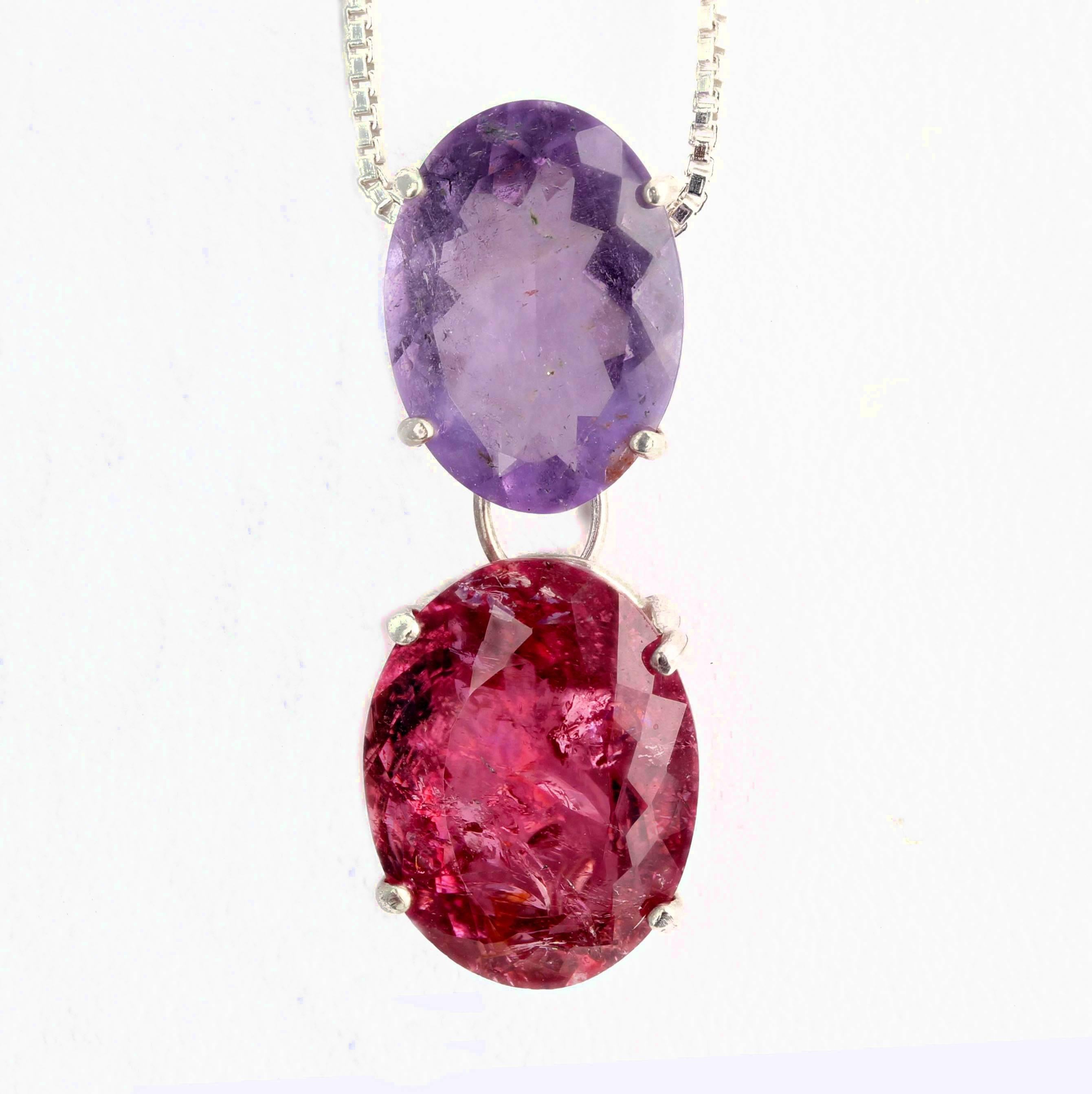 This bright reddish 8 carat Tourmaline (15.4 mm x 11.6 mm) dangles a beautiful 5 carat lavender color Tourmaline (14.1 mm x 10.1 mm) set in sterling silver.  It measures approximately 1.08 inches long and comes with a silver chain that fits through