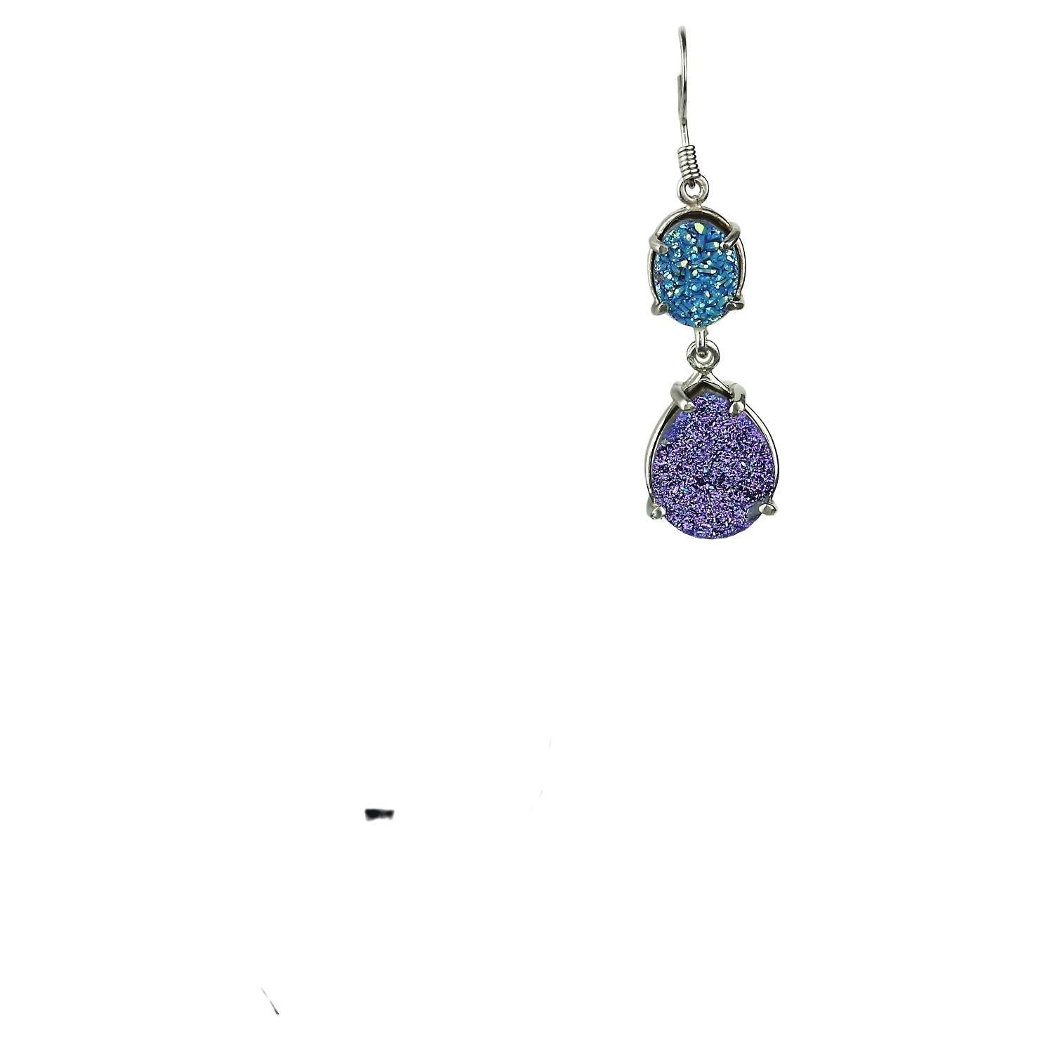 Sparkly Teal & Purple Druzy Dangle Earrings. Teal oval and Purple Pear shaped Durzys set in Sterling Silver Dangle from Silver Plated Stainless Steel earwires. Hinges at the top and bottom of the Teal Ovals maximize the movement and sparkle of these