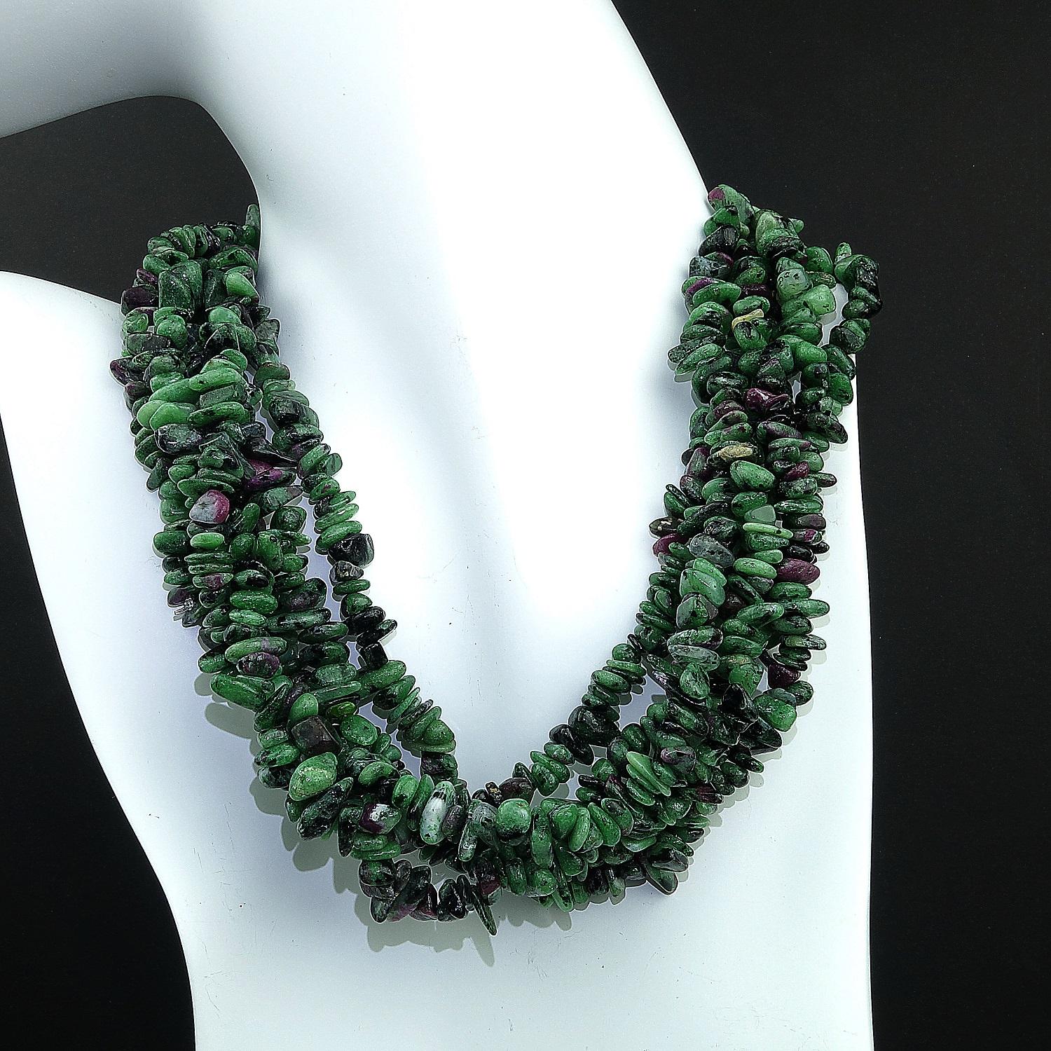 Three continuous strands of highly polished Ruby in Zoisite chips.  These lovely glowing gemstones can be worn long, 34 inches, or doubled and twisted as a six strand choker.  This versitile necklace comes with two clasps, gold tone and silver tone.