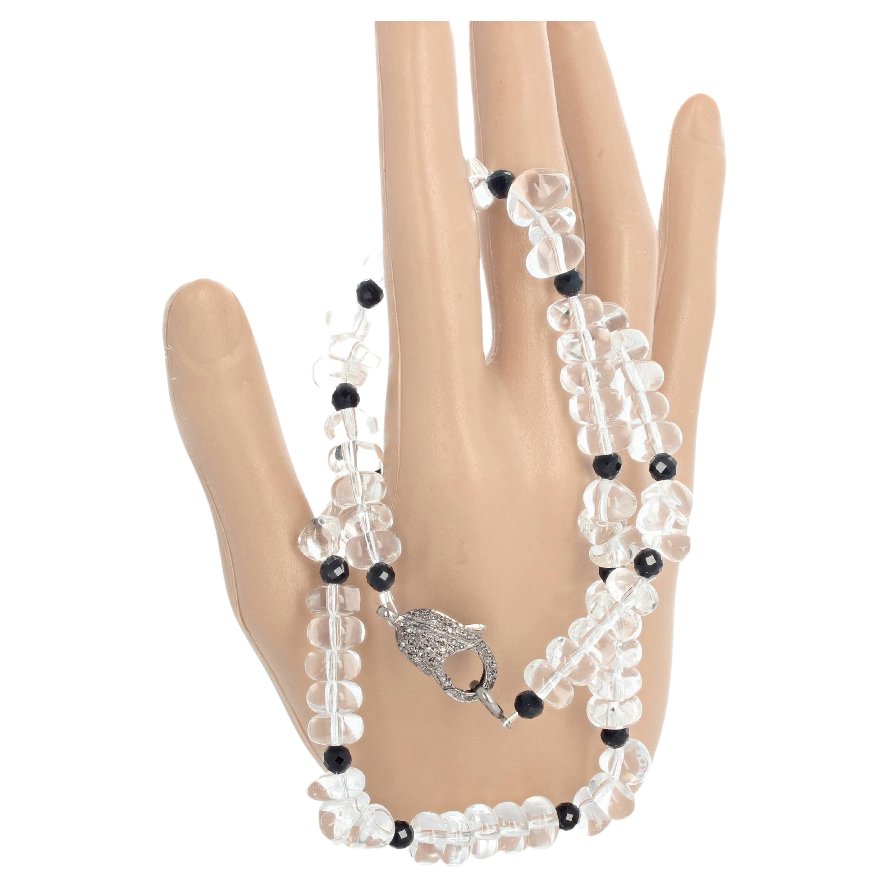 Sparkling translucent beautiful clear natural Quartz adorned with sparkling gem cut Spinel accents set in a necklace 17 inches long with a darkened sterling silver diamond encrusted clasp.  The tiny little diamonds in the clasp sparkle nicely so