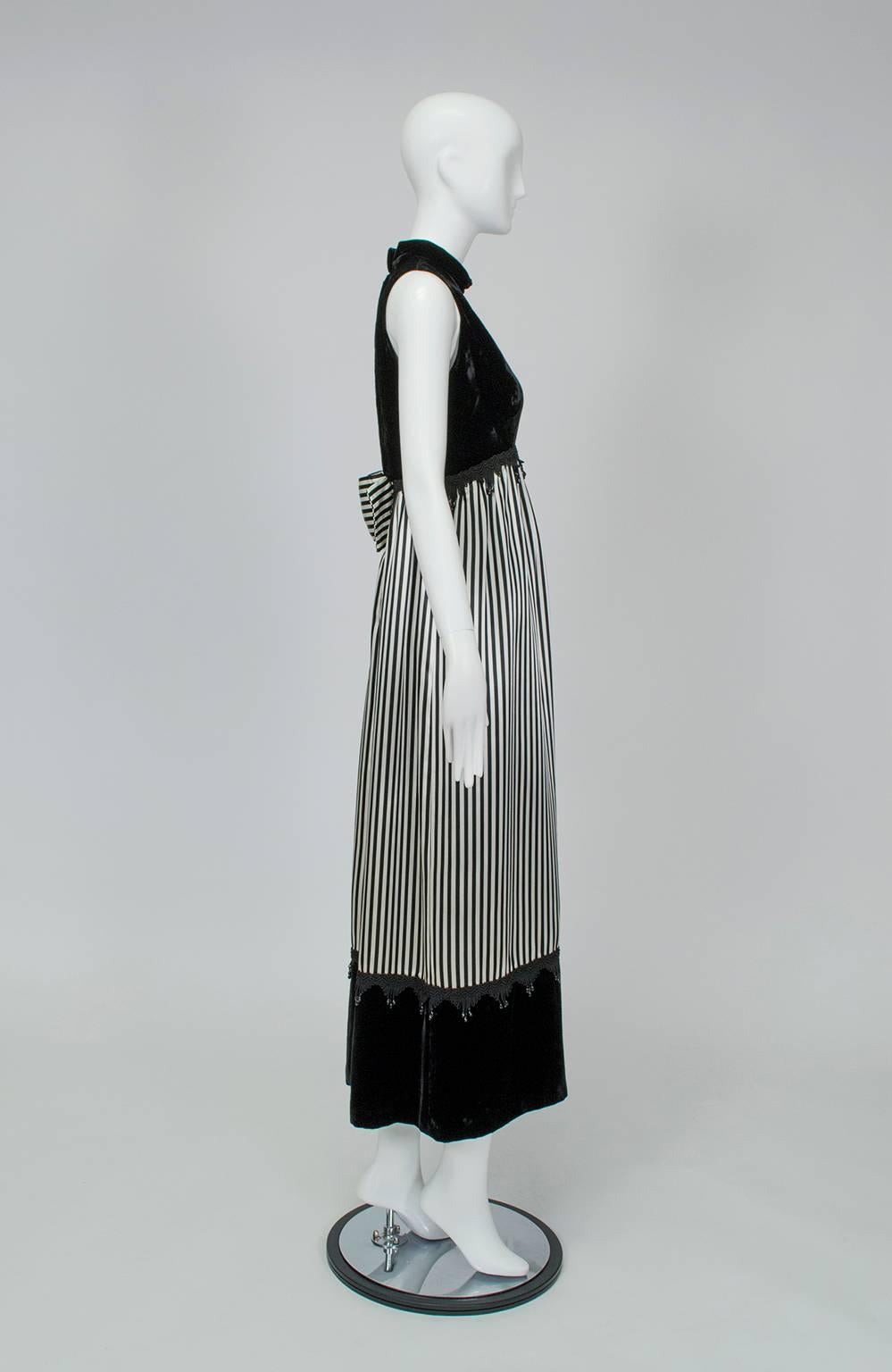 With multiple textures, hanging beadwork and a riot of ¼” stripes, this gown has a lot going on but manages to get all of it just right. Best on a statuesque figure with sculpted shoulders, this gown reminds us of a piece that might be worn on a