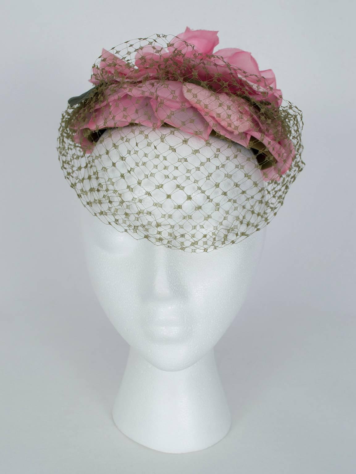 Favored by Audrey Hepburn and often photographed by Henry Clarke, French milliner Gilbert Orcel's hats are nothing short of wearable works of art. This one, with its playful pink and spring green color scheme, is supremely elegant due to its