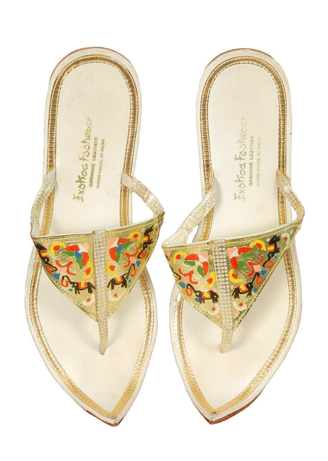 An immaculate pair of vintage gold sandals in a wearable modern size? With a Persian toe?! Yes Virginia, there is a Santa Claus.

Gold leather flat thongs with hand-painted triangular vamp and curled Persian toe; leather sole and insole.


material: