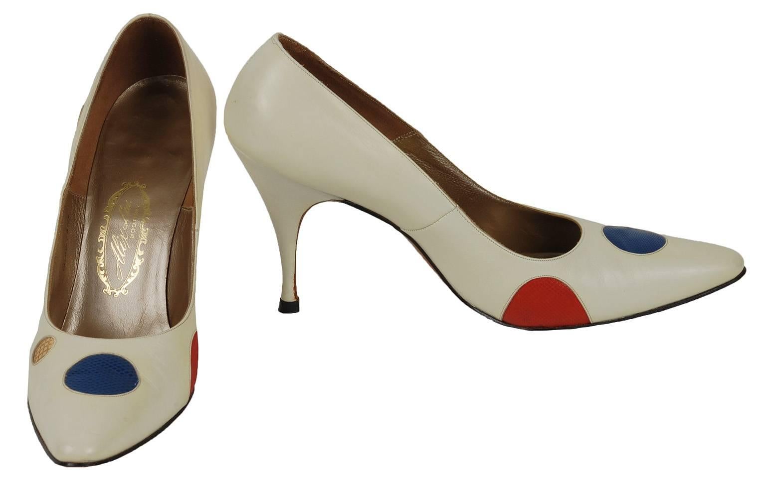 They may date from the 1950s, but they scream Eighties Nu Wave to us.  And thanks to polka dots in red, yellow, blue, green AND gold you can wear them with all the eras in between.

Ivory leather pointed toe pump inset with multicolored reptile skin