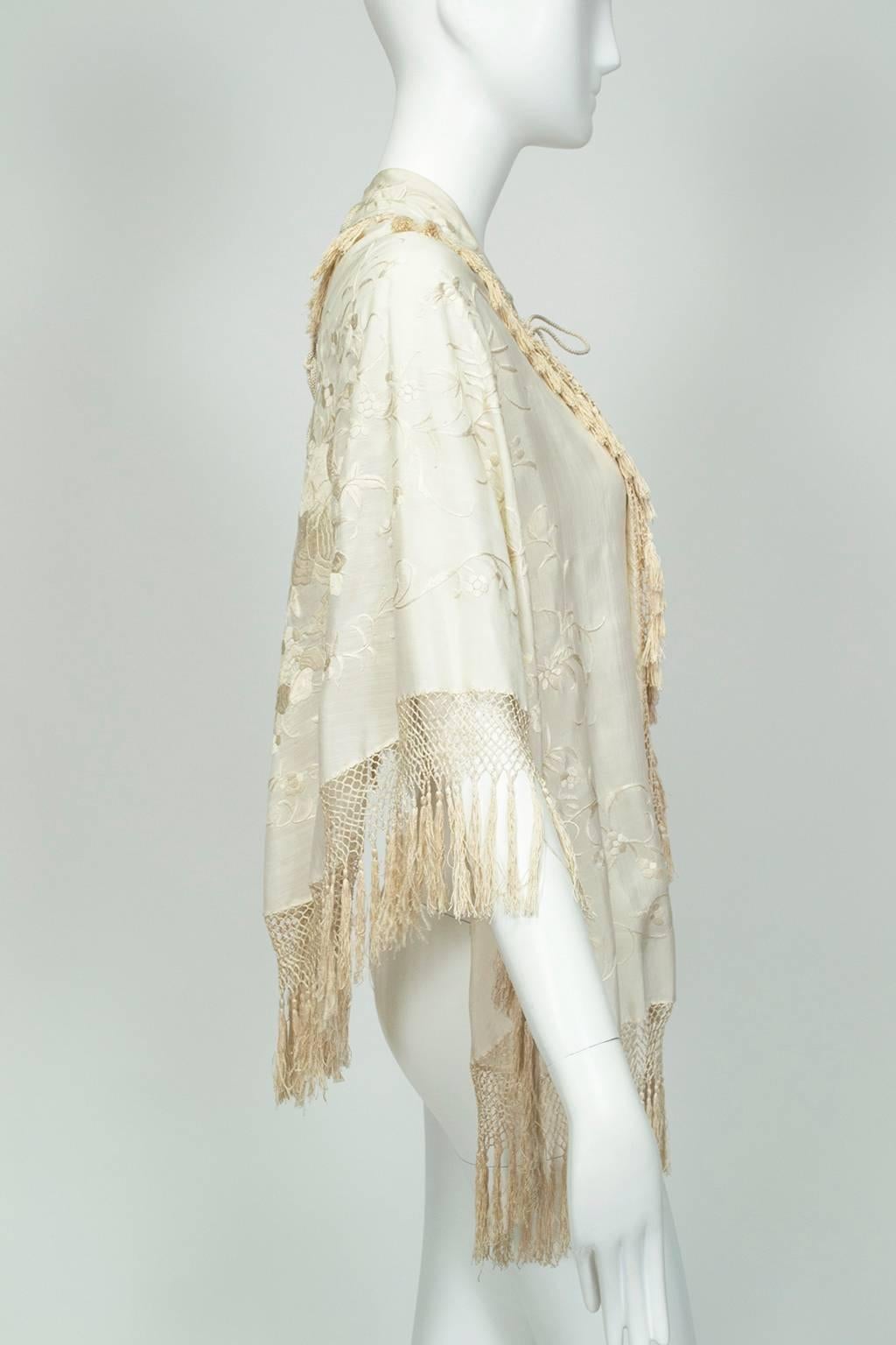 A breathtaking piece of history, this ethereal shawl is an ideal garment to represent “something (really) old” at the wedding, and short enough to be worn as a layering piece for years afterward; it even looks smart worn backwards! Unworn since its