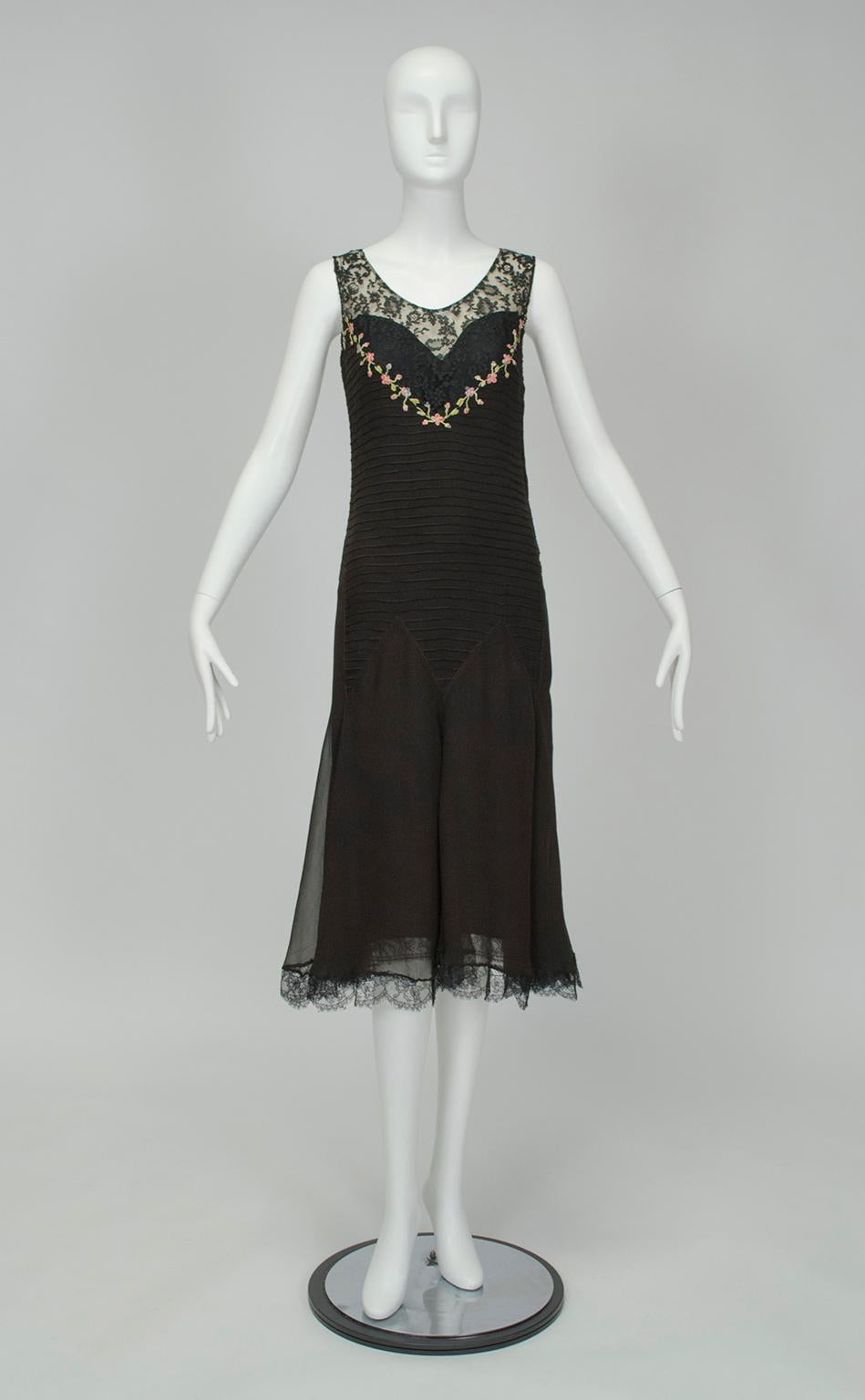 Unlike many 1920s dresses, the embellishment on this piece may not be immediately obvious. Closer inspection reveals that the dropped bodice is actually entirely horizontally pintucked and joined to the skirt with a zigzag waist seam. A fetching