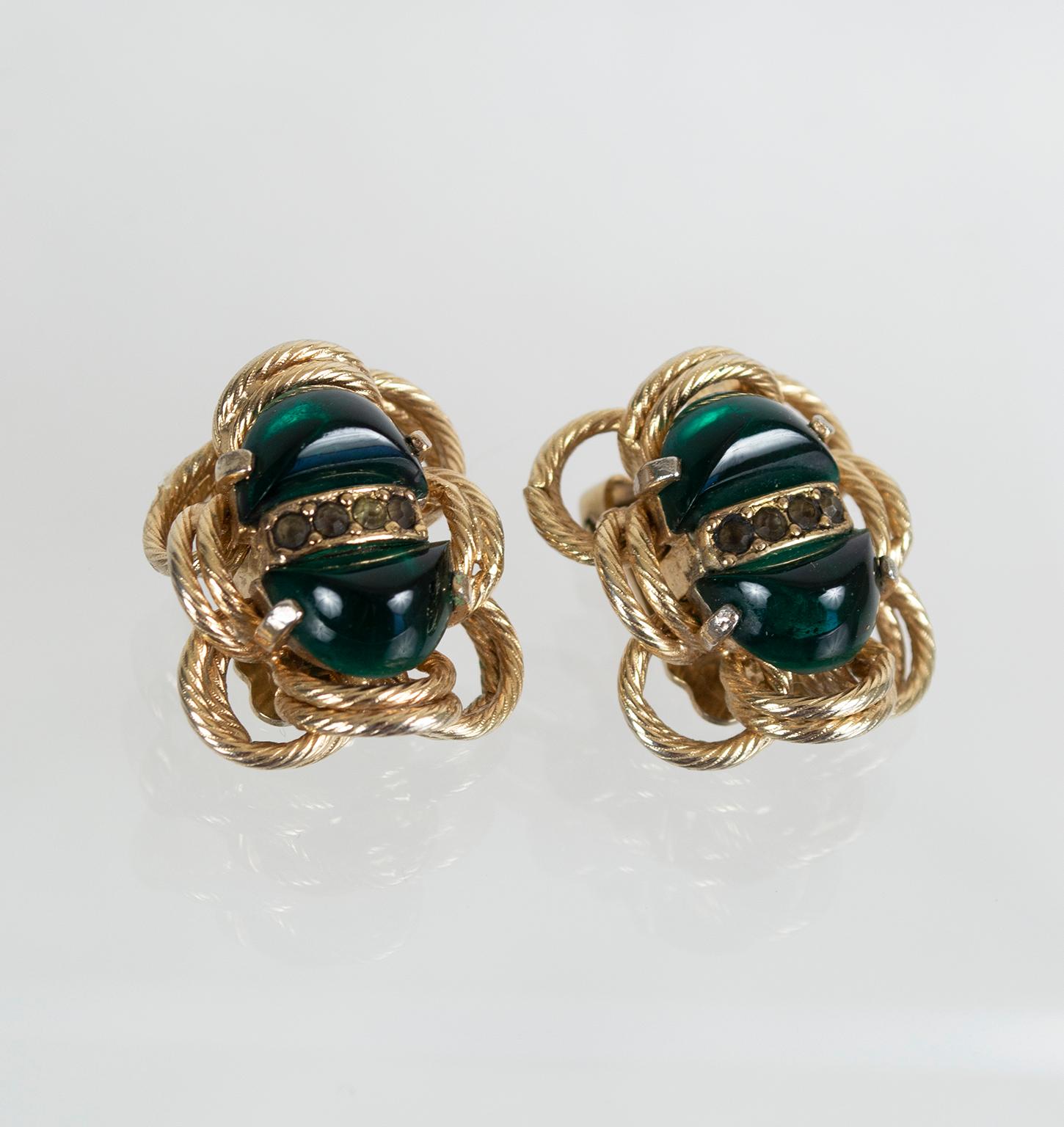 Though their emerald color and oblong shape are suggestive of scarab beetles, Eisenberg actually improved on nature by making these earrings of glass. Surrounded by bright goldtone metal 