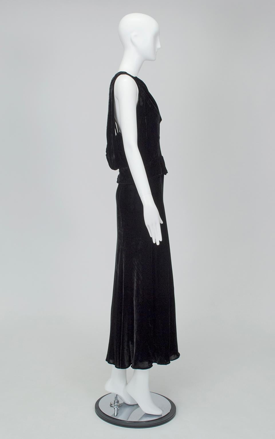 As beautiful coming as it is going, this unique gown is a perfect bridge between the designs of the Jazz Age and the Screen Age. The slashed peek-a-boo back upholds the liberation of the female form, while the draped bateau neckline,