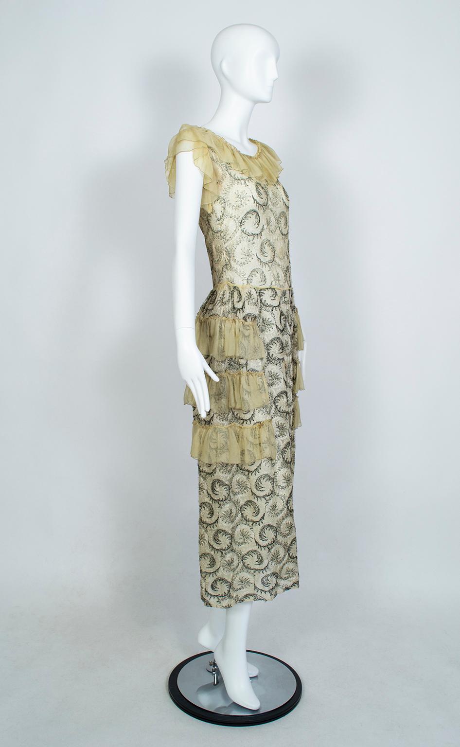 With snug bodices and wired hip panniers, Robes de Style struck a happy medium between the highly-ornamented gowns of the Victorian era and the slinkier drop-waist dresses of the Jazz Age. This one incorporates scrolling 2-tone silk embroidery to