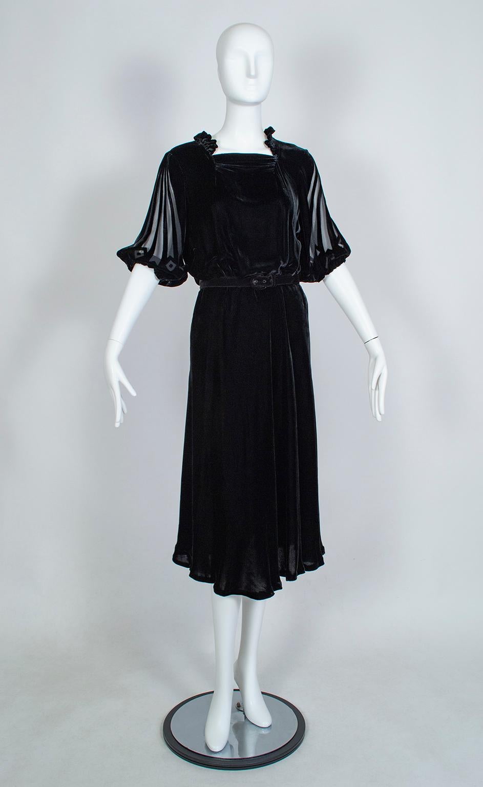 As people braced for war in the late 1930s, fashion responded by shortening hemlines and replacing bias silhouettes with more severe, military-inspired cuts. A true “black sheep,” this cocktail dress defied the trends bears many of the hallmarks of