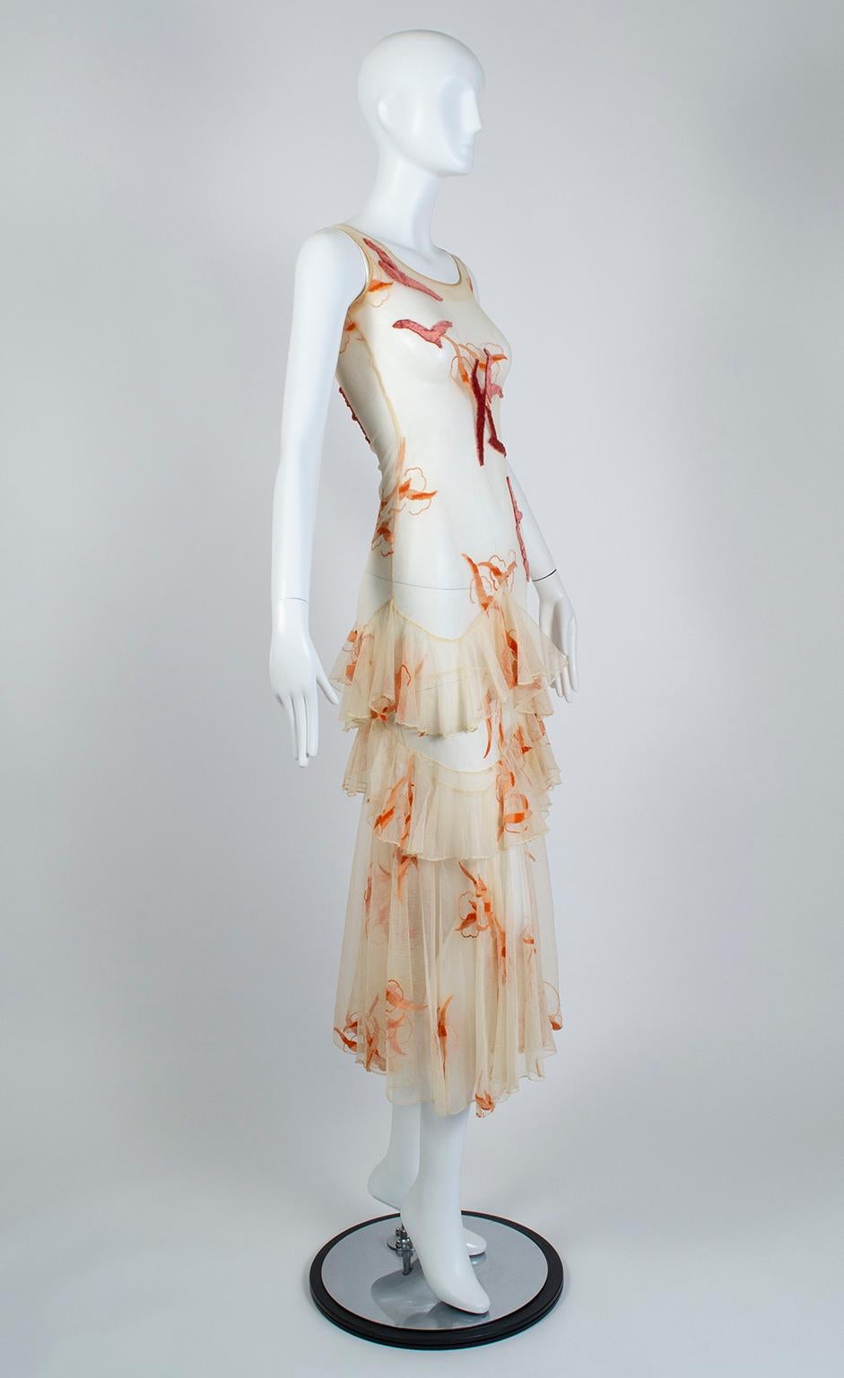 Fully restored, this breathtaking dress recalls the ethereal evening gowns designed by Jeanne Lanvin and Coco Chanel in the late 1920s. Using a skin-tight nude net body stocking as its base, the dress features a skirt with two tiers of ruffles sewn