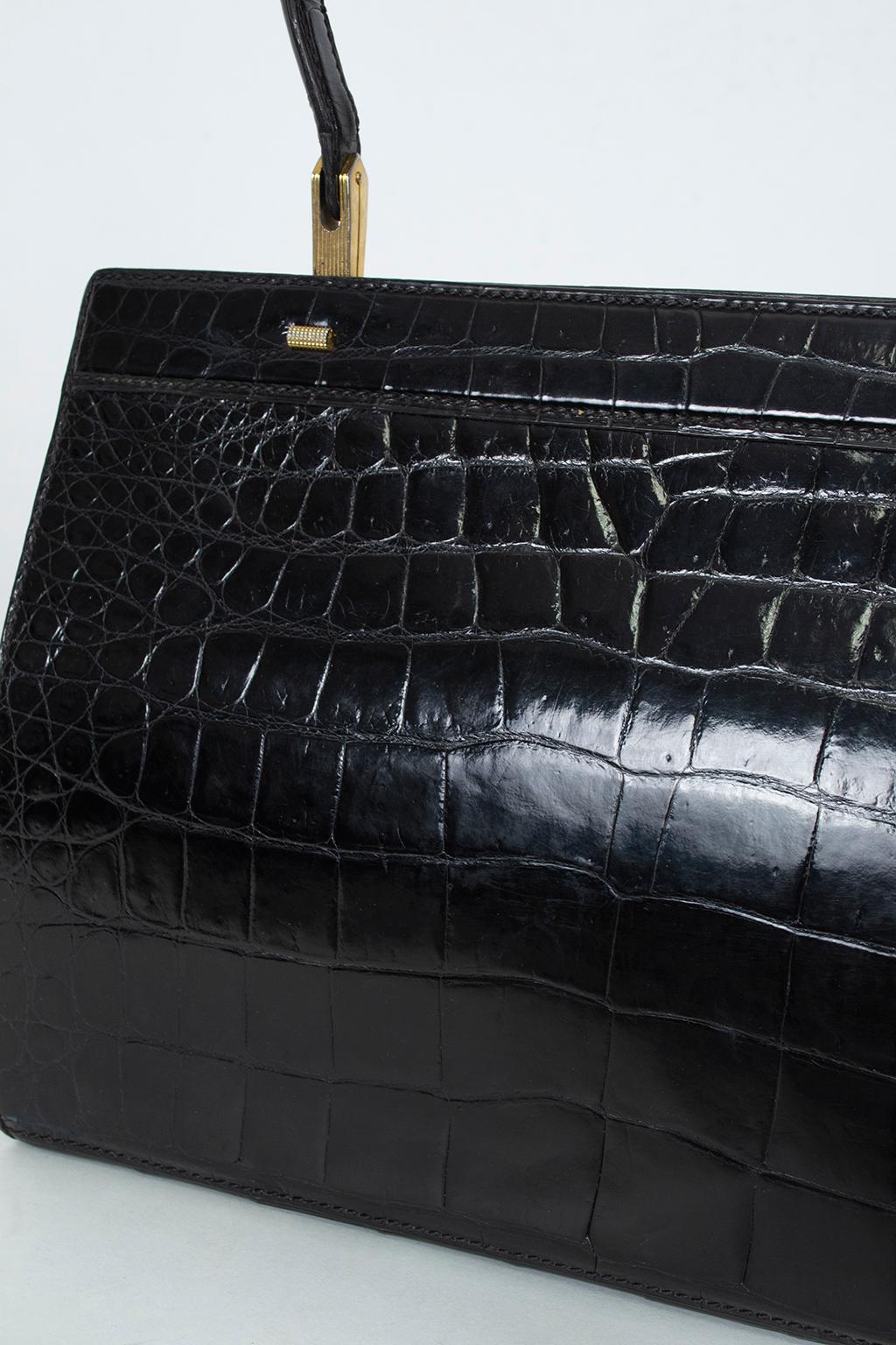 Do tidy alligator handbags invoke images of Grace Kelly carrying her iconic Hermès? Why not go one step further with a gloss black version from the actual House of Grimaldi? The very picture of ladylike good breeding, this top handle purse also