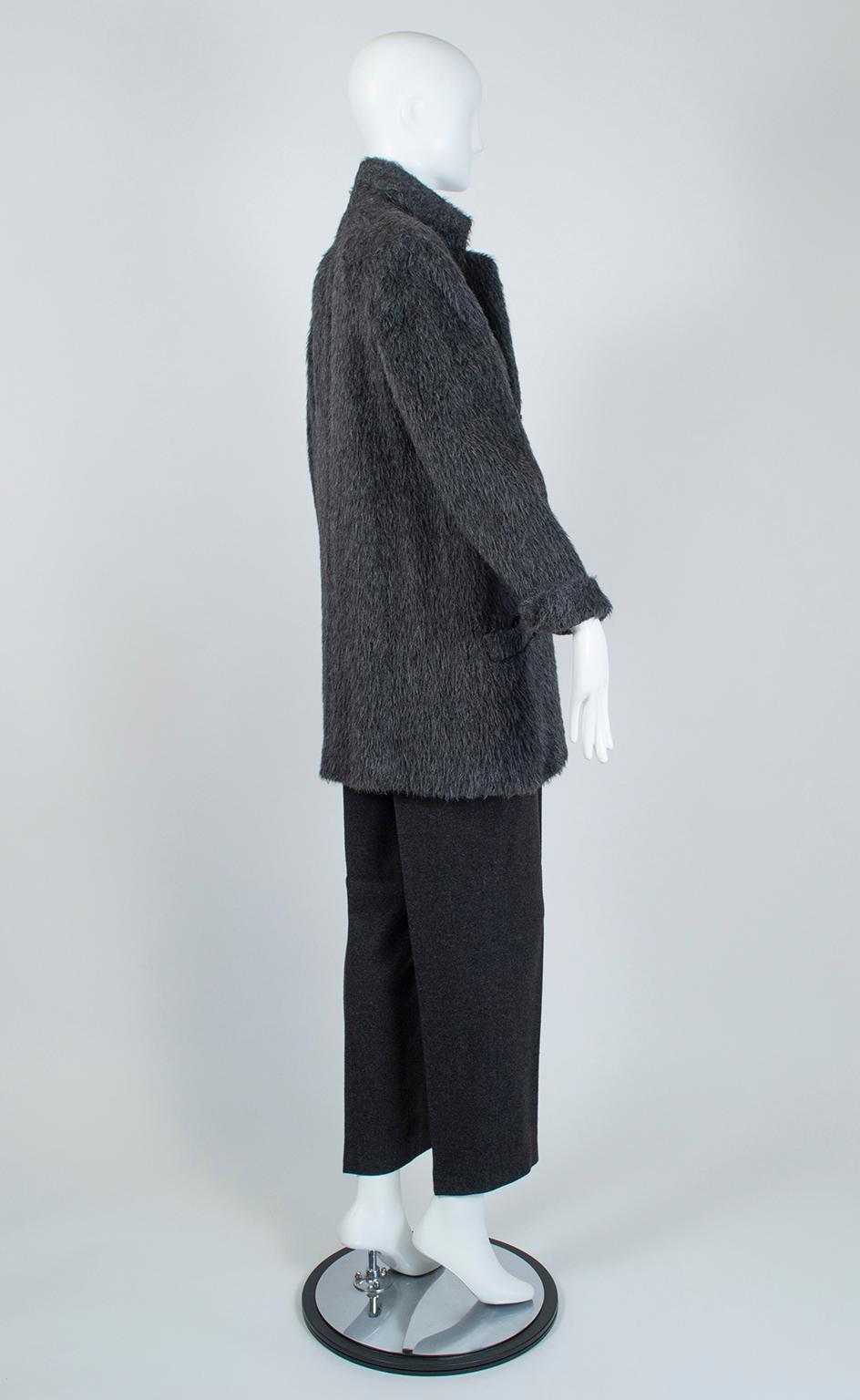 Like David Byrne’s “Big Suit” from the 1980s, this oversized suit makes a powerful statement despite its crisp, minimalist silhouette. Fuzzy, warm and richly textured, the jacket dominates the ensemble with its broad shoulders and long lines, while