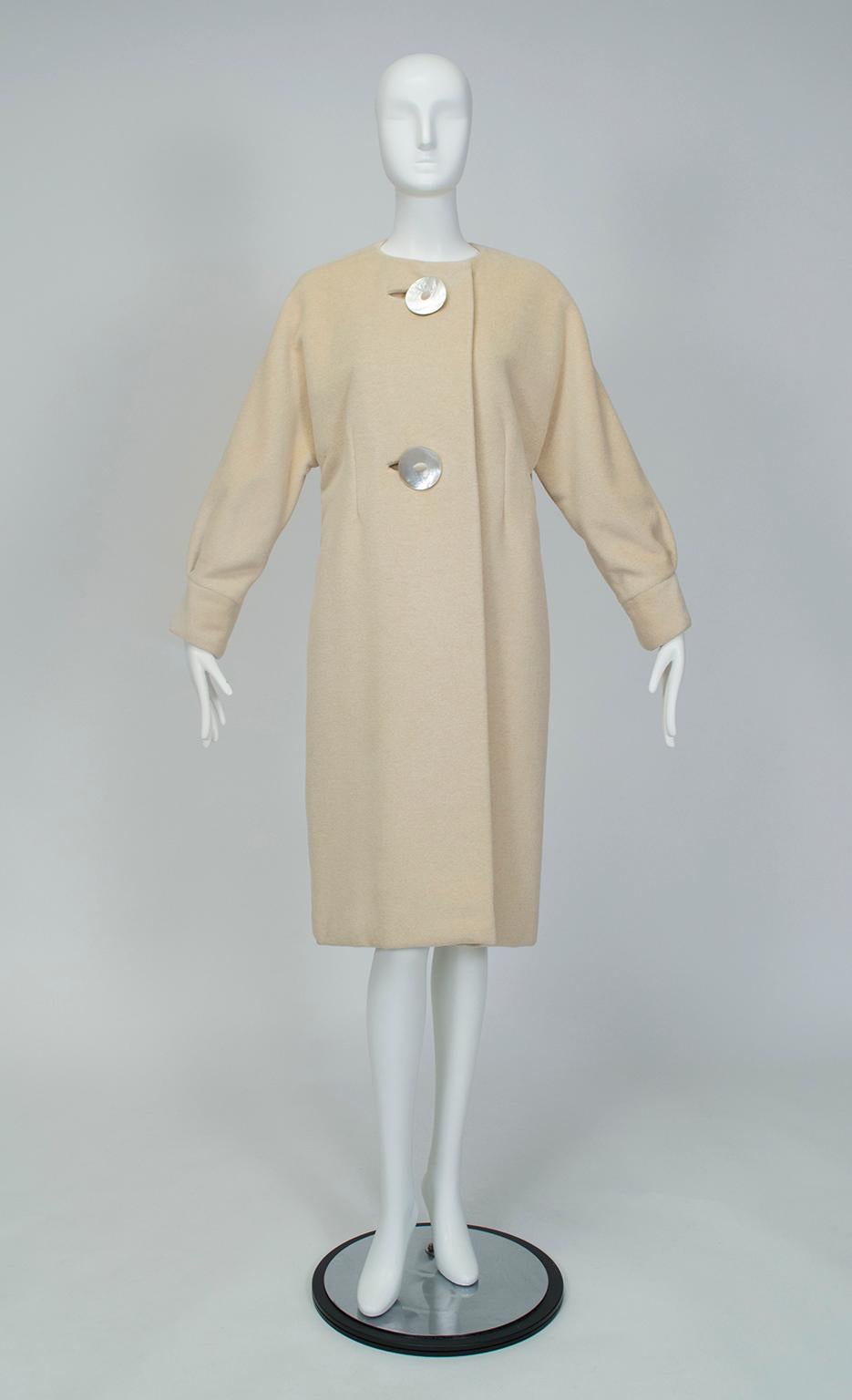 Beyond its minimalist silhouette and luxury-weight cashmere fabric, what sets this coat apart are its details, namely its chic balloon sleeves and massive mother of pearl buttons. Its timeless cut and neutral color will carry you from season to