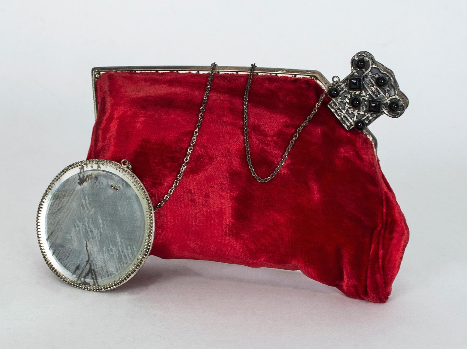 Beyond its luscious blood red color and plush velvet texture, this bag is a head-turner for its unusual polygonal shape and clever closure. The purse has no latch or snap, but instead uses a sprung metal claw--not unlike a hair ornament--to pinch