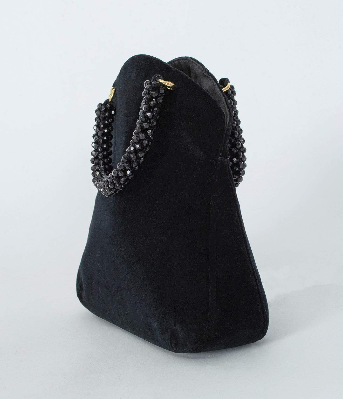 A significant departure from his loud psychedelic prints, this subdued black evening bag might be the last one you ever carry. With its unique hourglass shape, muted goldtone hardware and saturated black color, it will pair with almost anything. Its