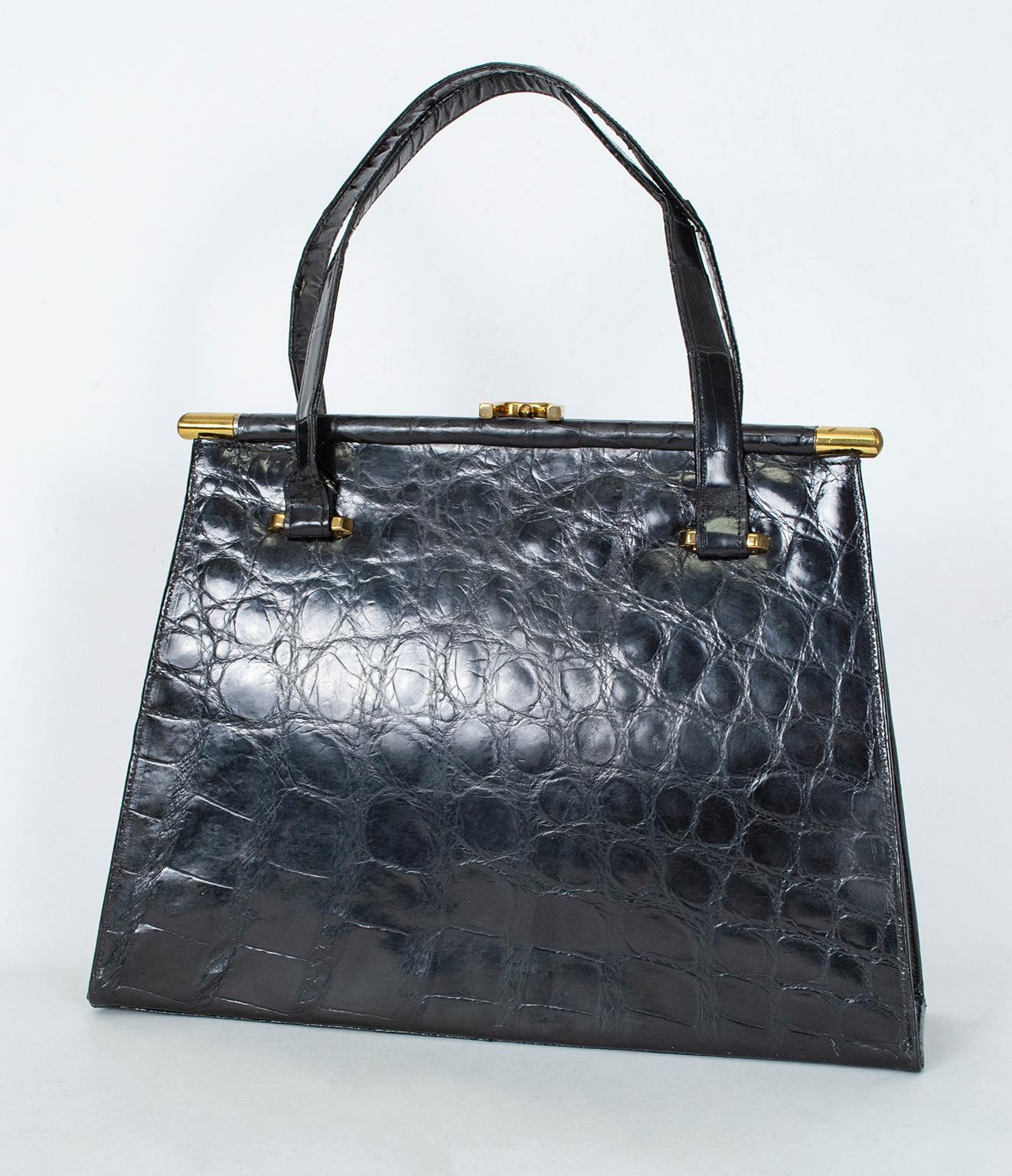 An icon of mid-century style, this classic geometric handbag not only has the shape that toasted the times, but a unique gold dowel-style top frame and a lucky horseshoe clasp. There’s even a matching coin purse!

Gloss black alligator handbag with