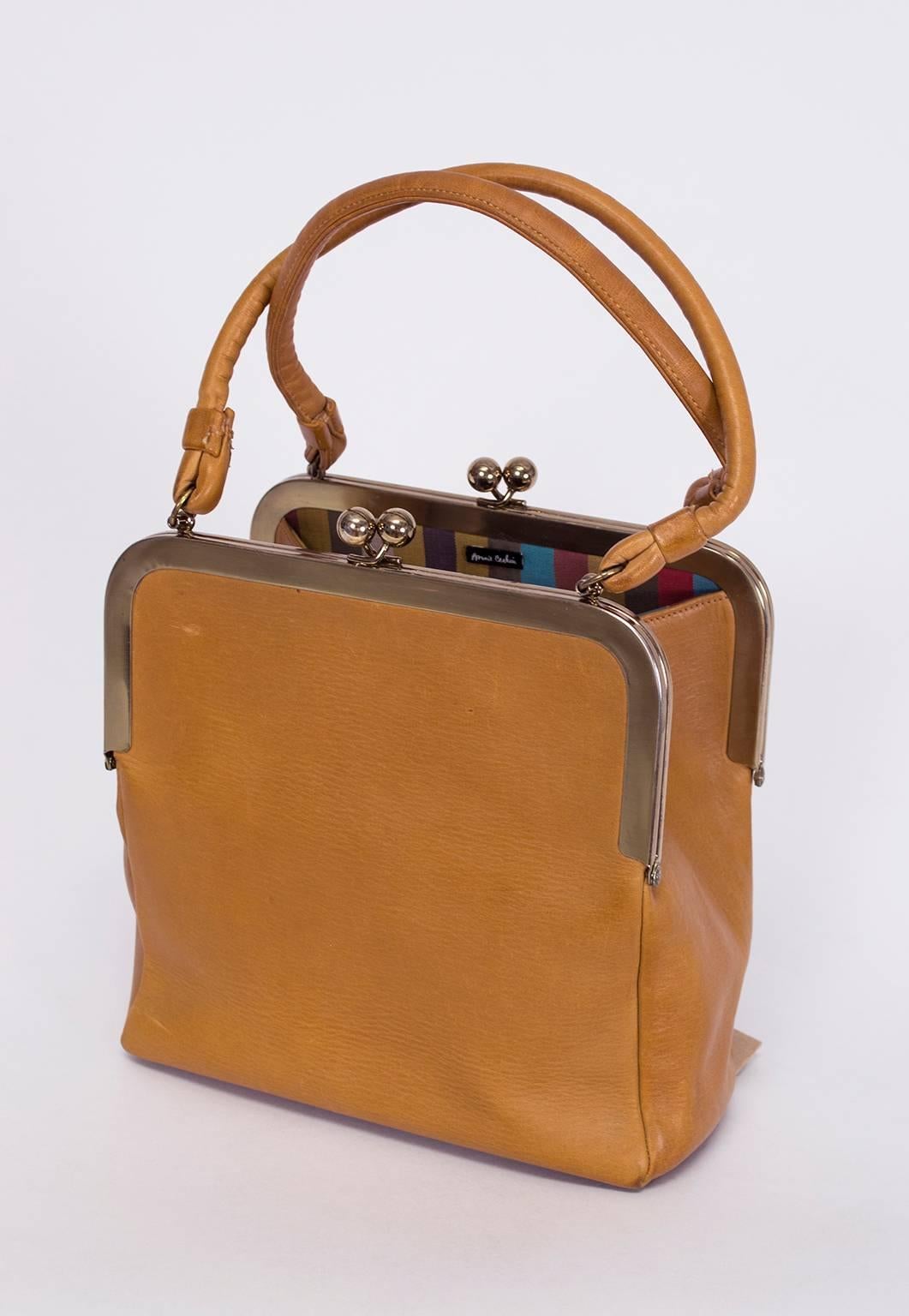 Bonnie Cashin joined handbag manufacturer Coach in 1962 and launched its women’s accessories division to nationwide acclaim.  Though all her original handbags enjoy reverential collectible status, this square double kisslock remains one of her most
