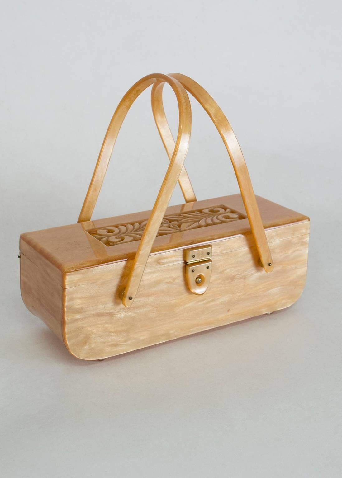 So much more than a handbag, this gorgeous purse resembles a piece of Heywood-Wakefield furniture more than a fashion accessory.  From its curving “waterfall” edges to its remarkable luster to its pierced relief lid, this purse is true mid-century