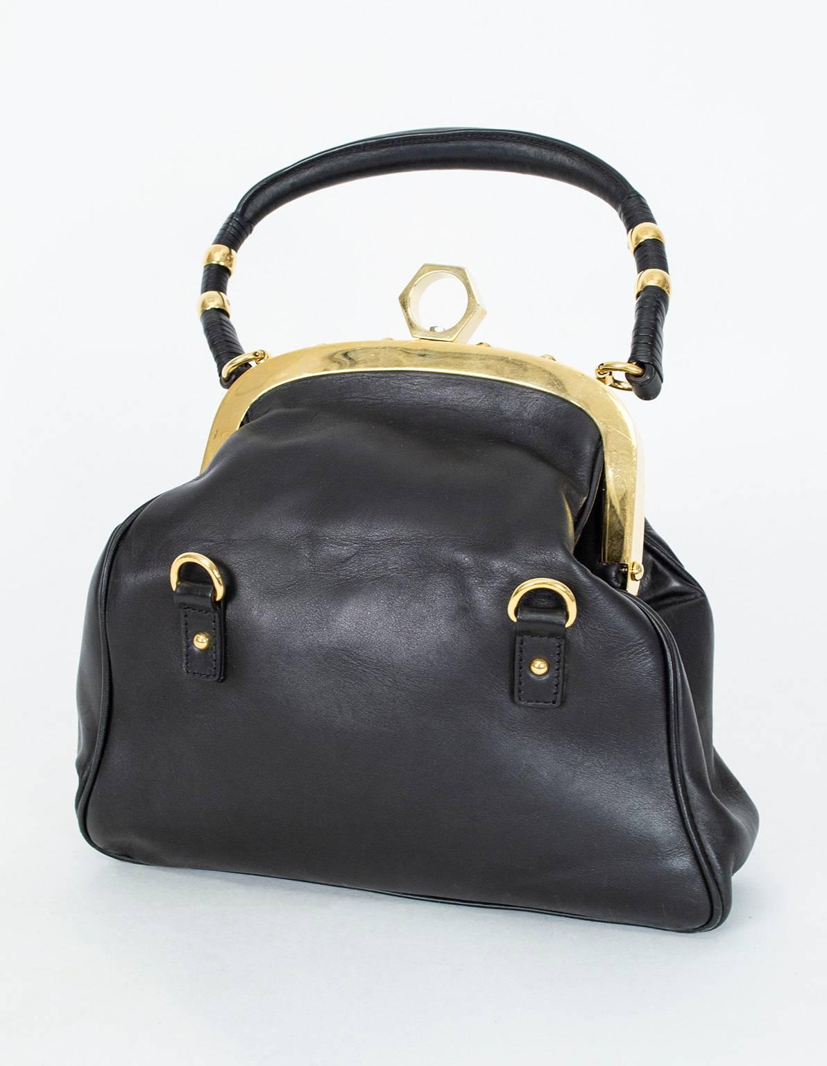 One of Zac Posen's early handbag designs, the Alexia frame bag instantly became a hallmark of Posen's catalogue thanks to its spacious interior, ever-so-slightly Bohemian silhouette and long top handle, which permitted it to be carried over the