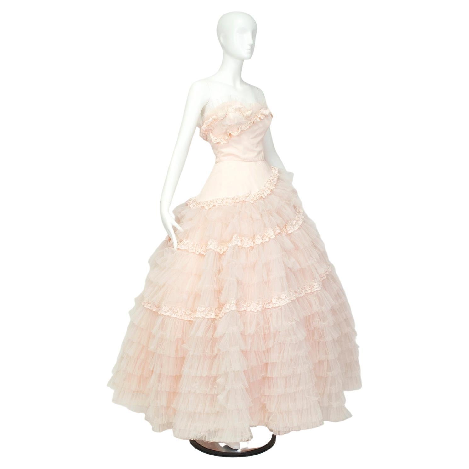 A confection of a gown, from its color to its spiral texture to its 27-foot sweep. Breathtakingly feminine, this dress literally and figuratively dominates every room it enters, and thanks to its whisper pink color it would make a devastating