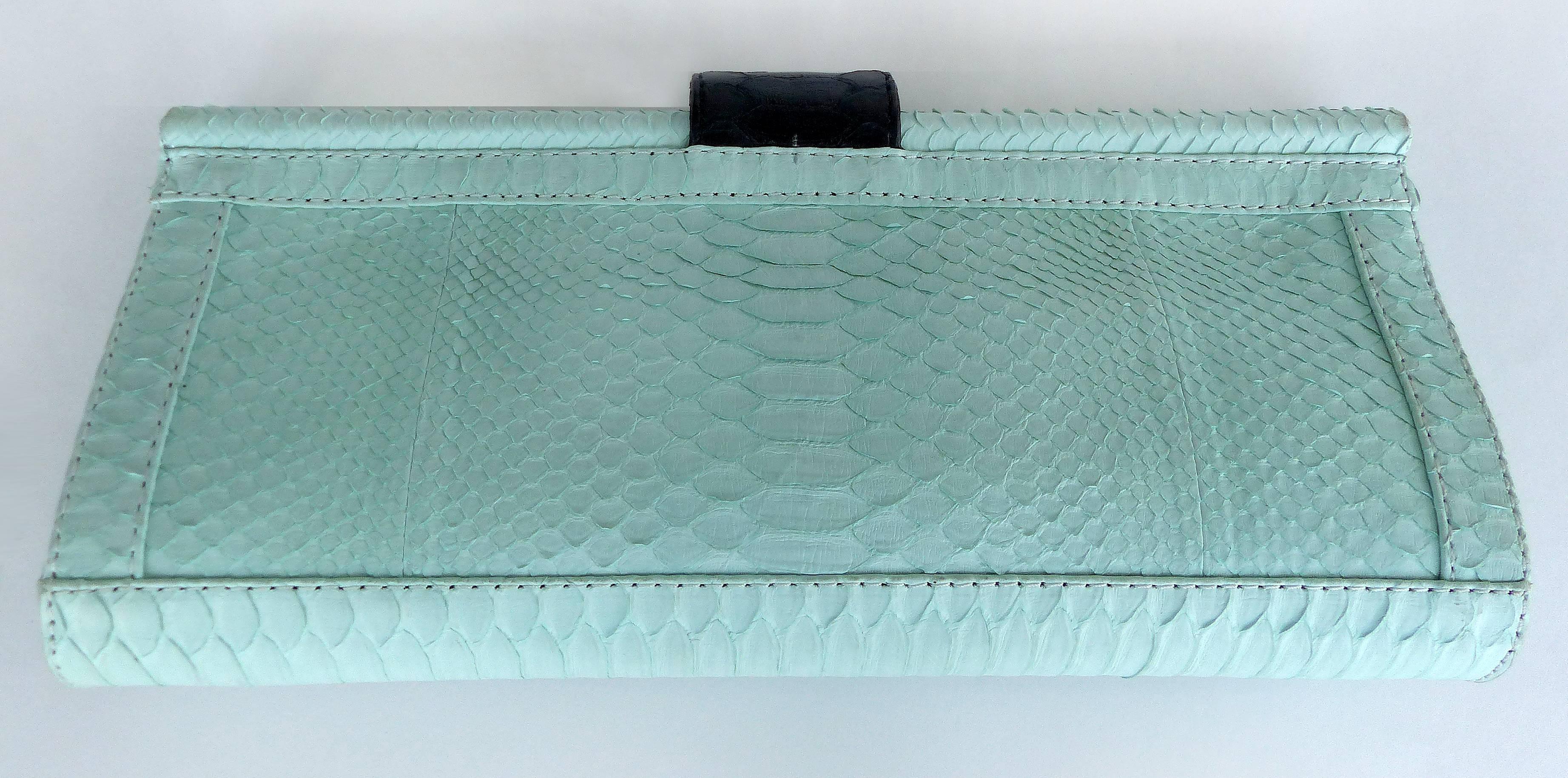 
Offered for sale is a large "Oscar" clutch with a hand-painted python front and mint colored python body. Designed in Bali by Glen Arthur for GaBag Co., this larger clutch opens to reveal a zippered interior pocket and ultrasuede lining.