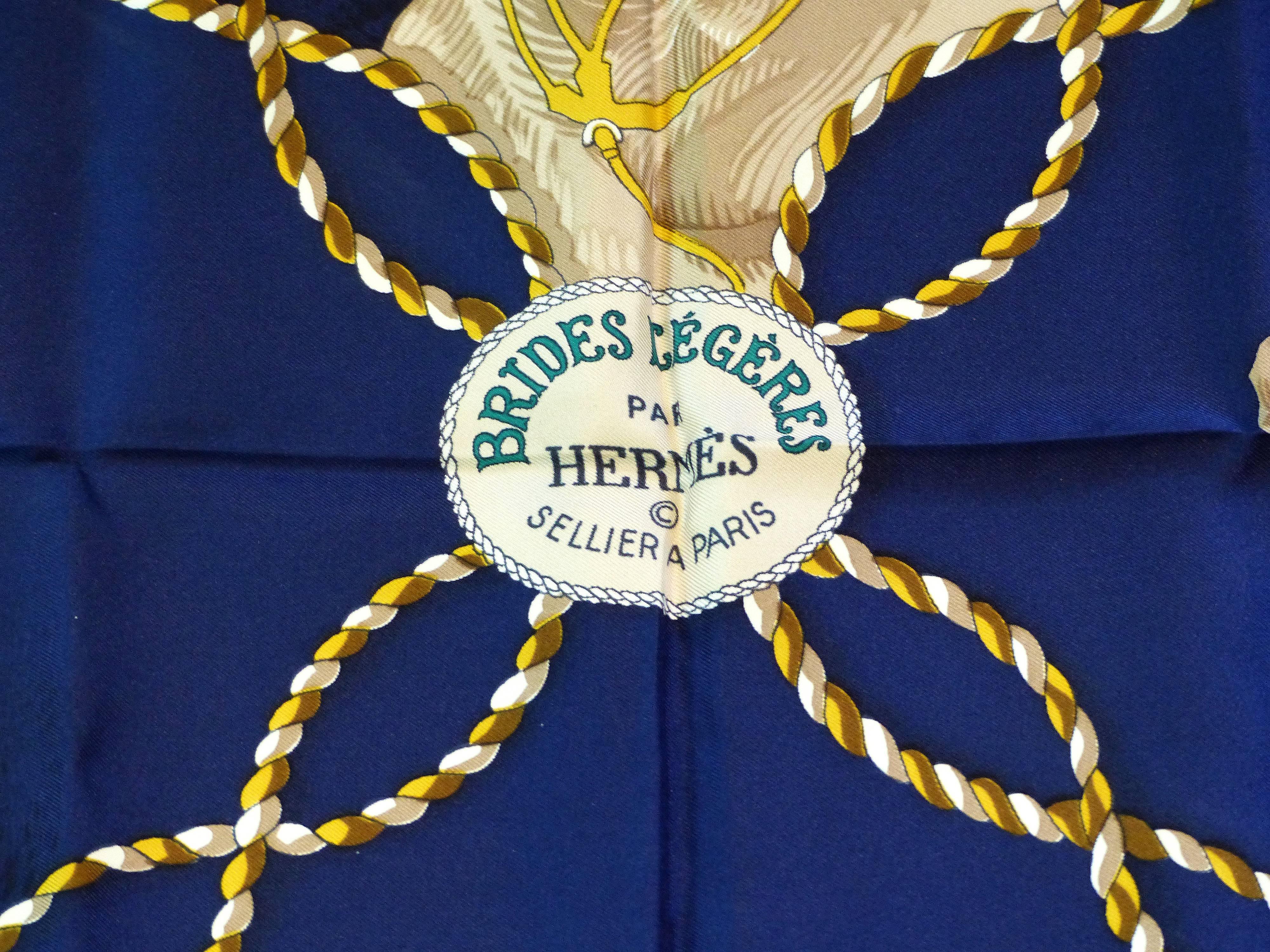 Offered for sale is a striking horse motif silk scarf titled  "Brides Legeres" from Hermes. This circa 1980 scarf was designed by Françoise Heron and was acquired from a collector and has not been worn. The scarf has the original folds and