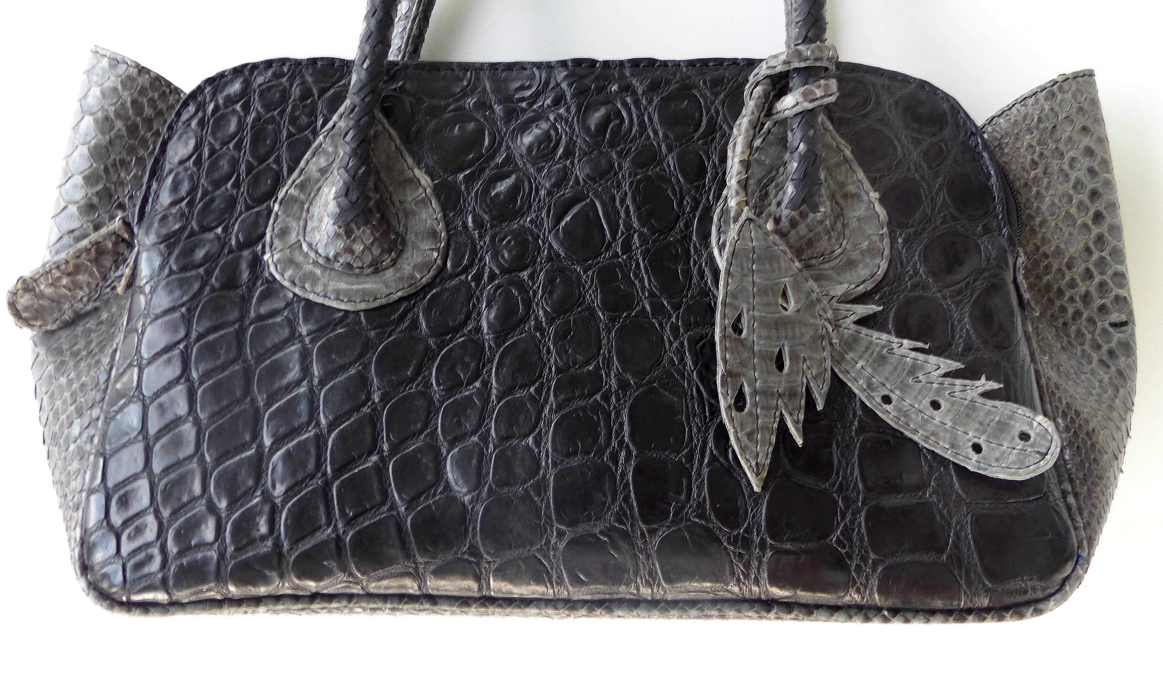 

Offered for sale is the smaller version of the "It" bag in black salt water crocodile and gray rubberized python side panels and details. Designed by Glen Arthur from his workshop in Bali, Indonesia for GaBag Co. This wonderful bag is