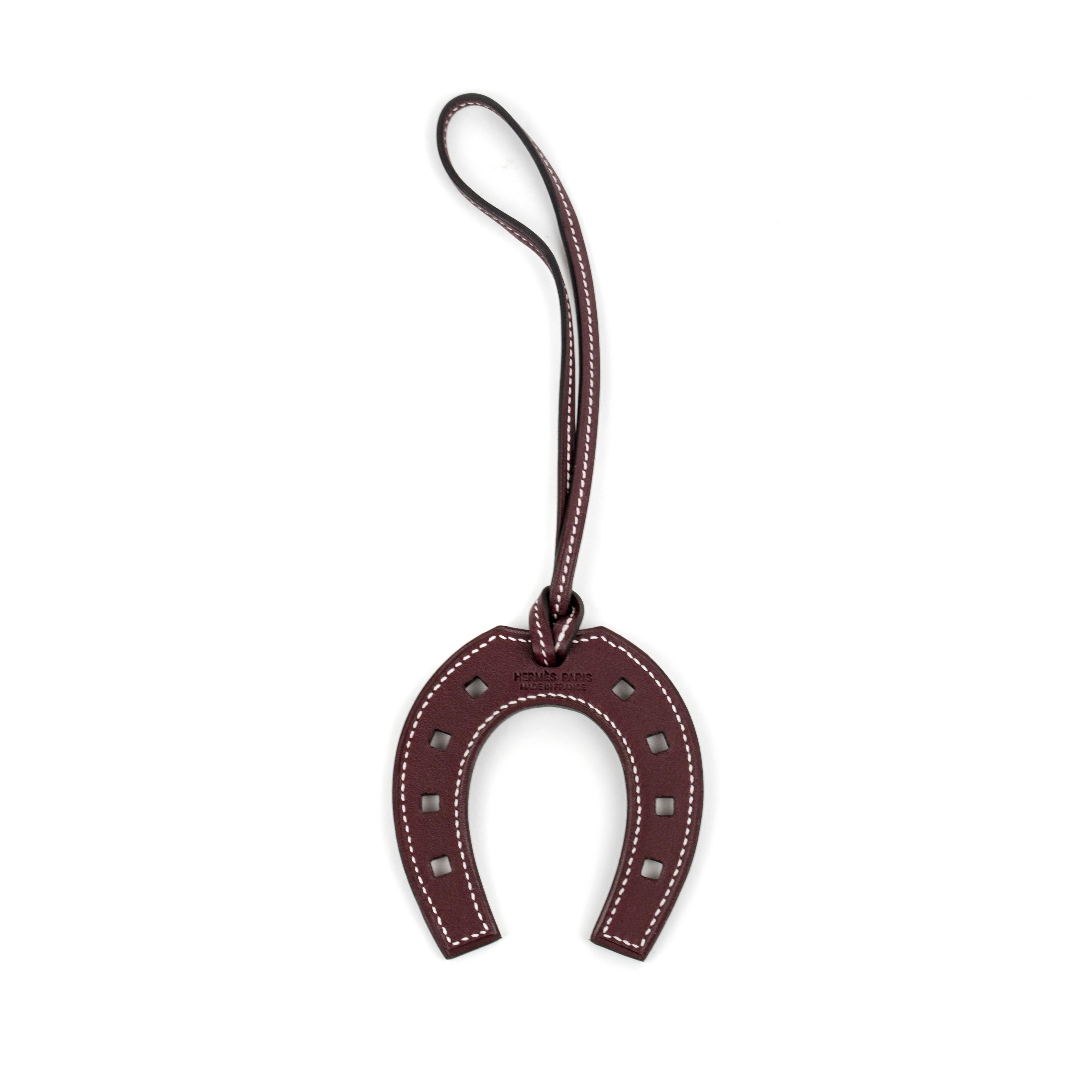 Brand New, fresh from store and never worn Hermes Paddock (Horseshoe Charm) in Bordeaux Color. This nice accessory for bag is extremely rare and not easy to get at boutique. The Paddock charm has been just picked up at Hermes store and selling as it