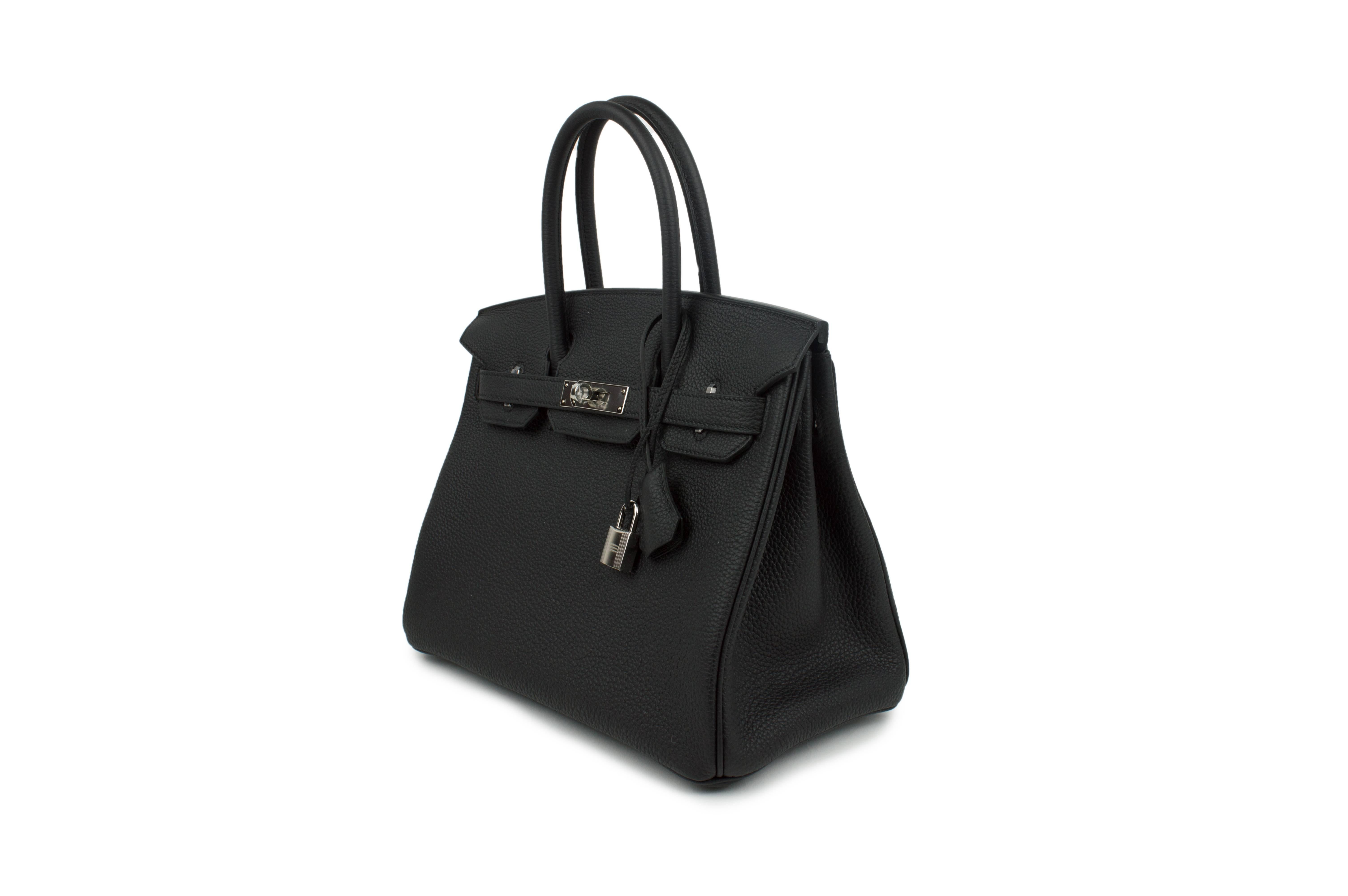 The new Hermès Birkin 30 cm Noir bag is a real masterpiece of the fashion industry. It is made of high quality leather and trimmed with silver accessories. Such handbag is a positional good emphasizing the irreproachable sense of style of its owner,