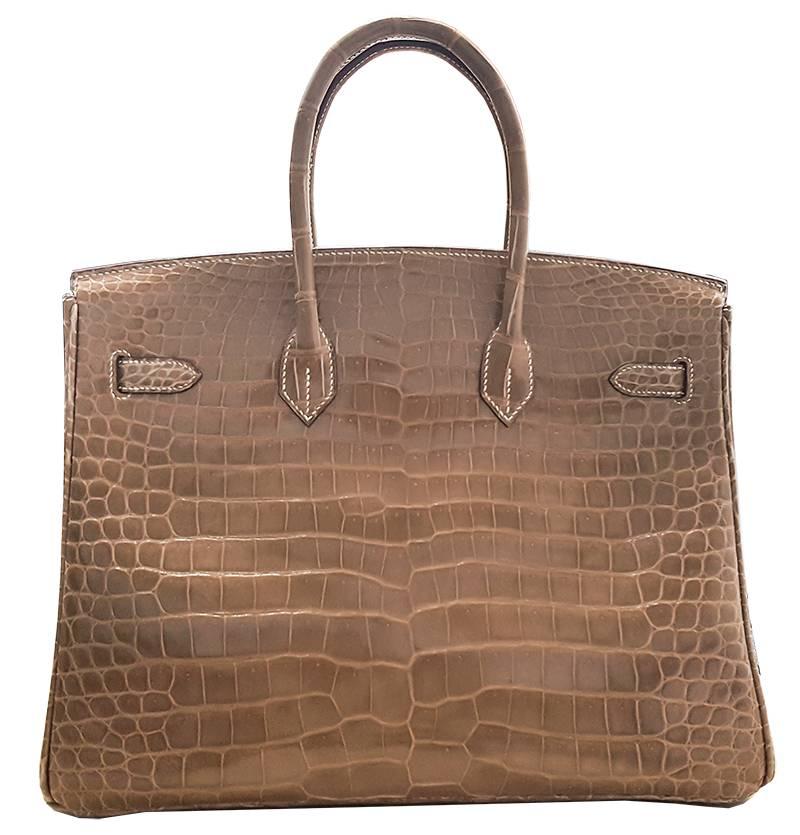 HERMES 35cm Poussiere Porosus Birkin Crocodile Bag with Gold Hardware
100% Authentic Hermes Birkin Bag
COLOR: 
MATERIAL: Crocodile
HARDWARE: Gold
ORIGIN: France
CONDITION: Excellent/Pristine
INCLUDES: Dustbag, lock, and key