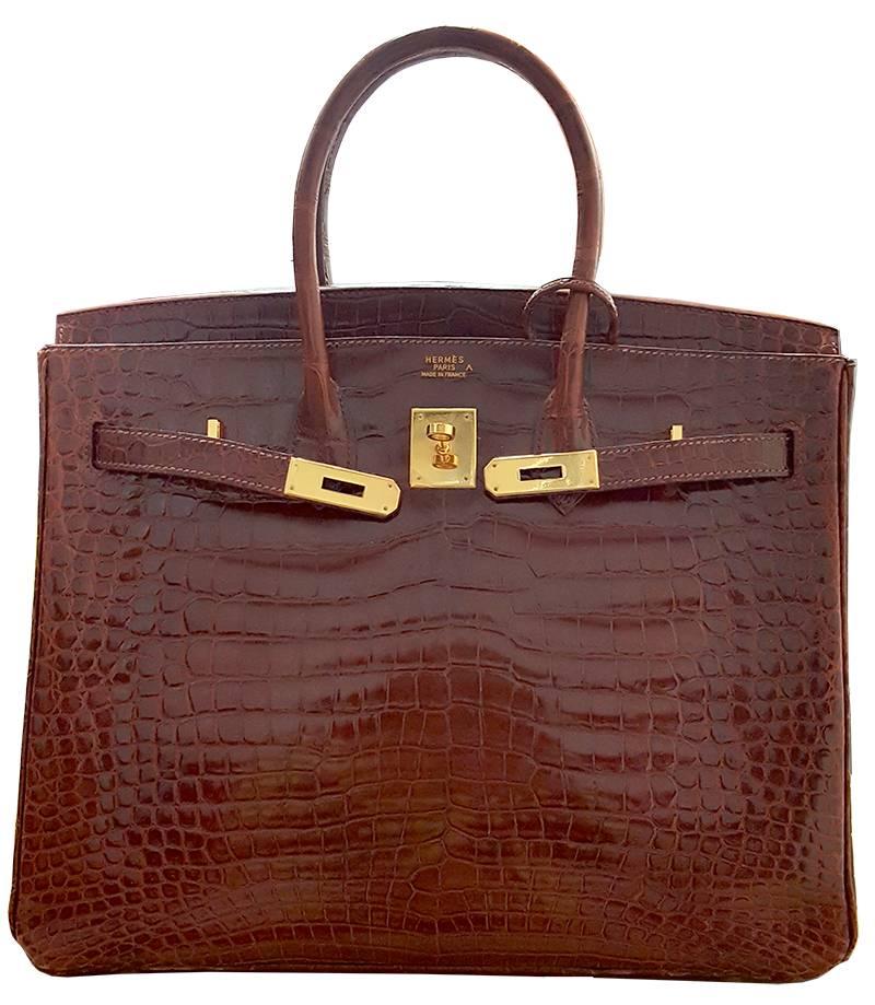 HERMES 35cm Rot Orange  Birkin Bag mit Krokodil
100% authentische Hermes Birkin Tasche
FARBE: Bourgogne
MATERIAL: Porosos-Krokodil
HARDWARE: Vergoldet
URSPRUNG: Frankreich
ZUSTAND: Unberührt
INKLUSIVE: Staubbeutel, Clochette, Schloss und Schlüssel.