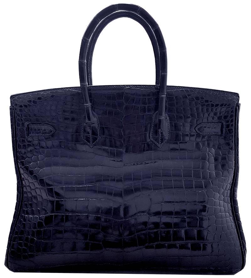 HERMES 35cm Dark Blue Birkin Crocodile Bag with Silver Hardware
100% Authentic Hermes Birkin Bag
COLOR: Black
MATERIAL: Crocodile
HARDWARE: Silver
ORIGIN: France
CONDITION: Pristine
INCLUDES: Dustbag, lock, and key