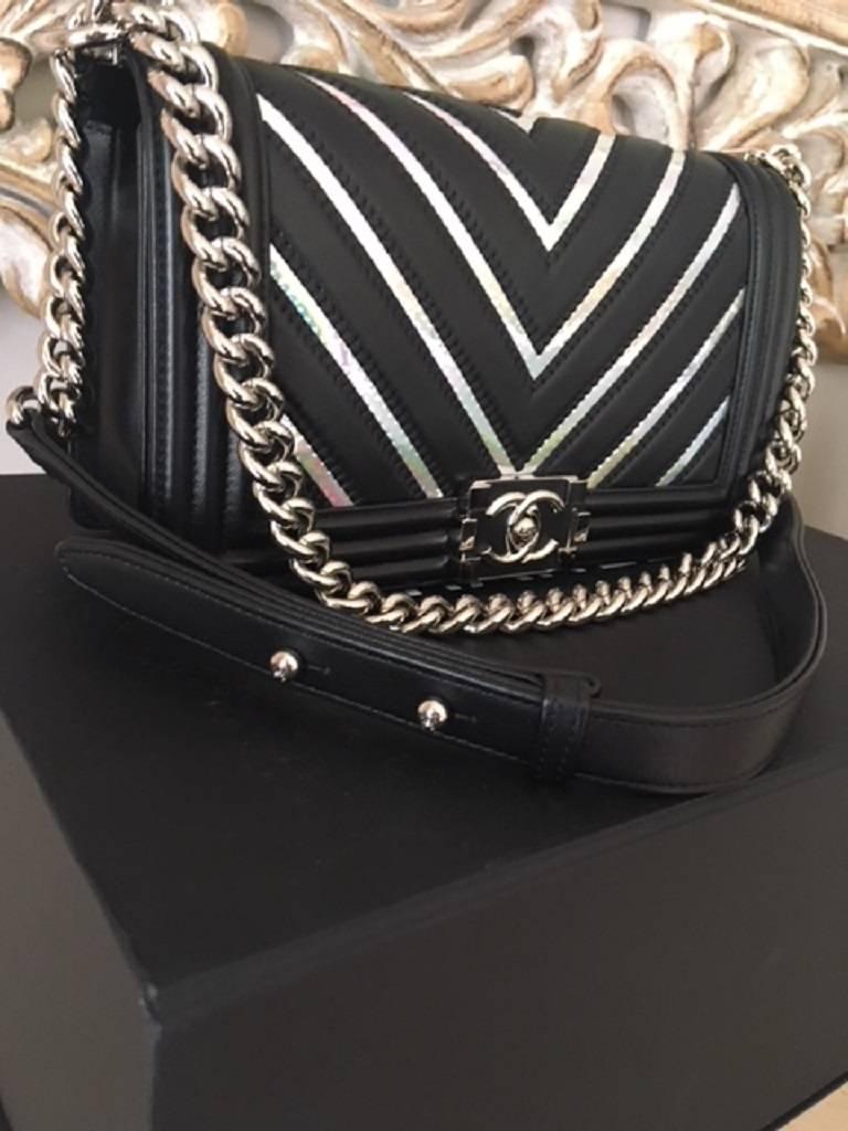 STORE FRESH. 

This medium boy bag is part of the 2017 Chevron range. Features the stunning individual Iridescent PVC on the Black Lambskin Leather. Bag is brand new in the box. Internally is the 1 open pocket for storage space. Bag comes Verified