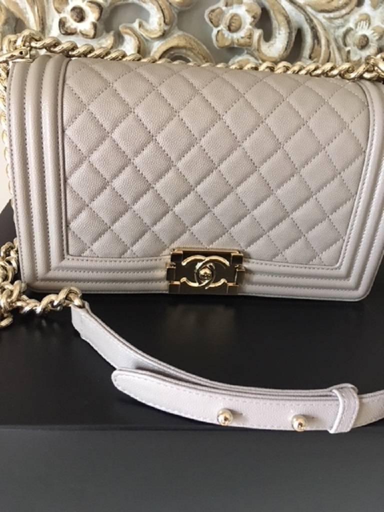 This stunning beige boy bag features the quilted caviar grain leather with the gold metal hardware. The bag is BRAND NEW and comes with a verified certificate of Authenticity by Lollipuff.  The bag features 1 internal pocket with the outside CC lock